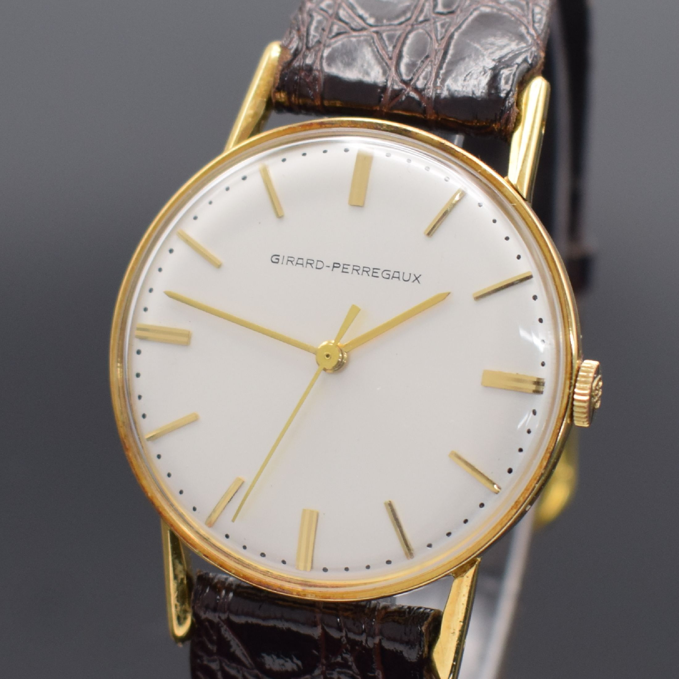 Detail a: GIRARD PERREGAUX Herrenarmbanduhr in GG 750/000, Schweiz um 1965, Handaufzug, Boden aufgedr., silb. Zifferbl. m. gold. Std.-Ind. & Zeigern rest., ...
