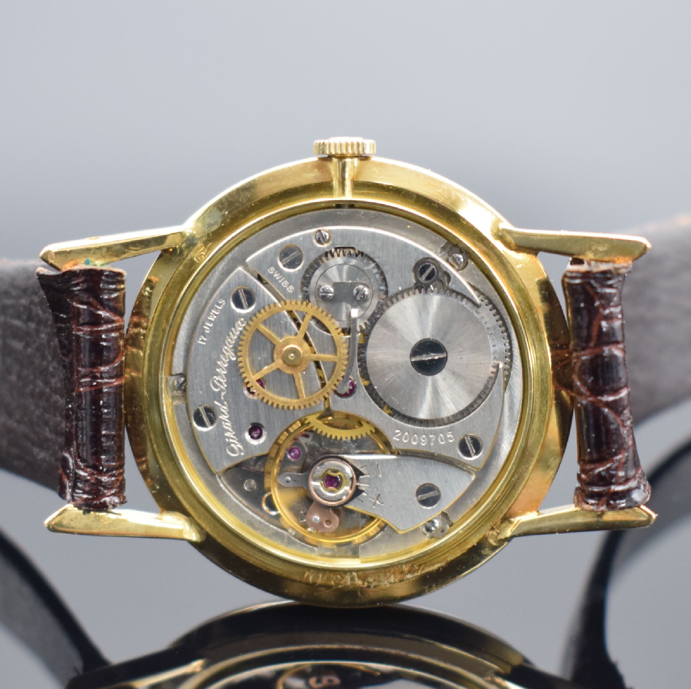 Detail e: GIRARD PERREGAUX Herrenarmbanduhr in GG 750/000, Schweiz um 1965, Handaufzug, Boden aufgedr., silb. Zifferbl. m. gold. Std.-Ind. & Zeigern rest., ...