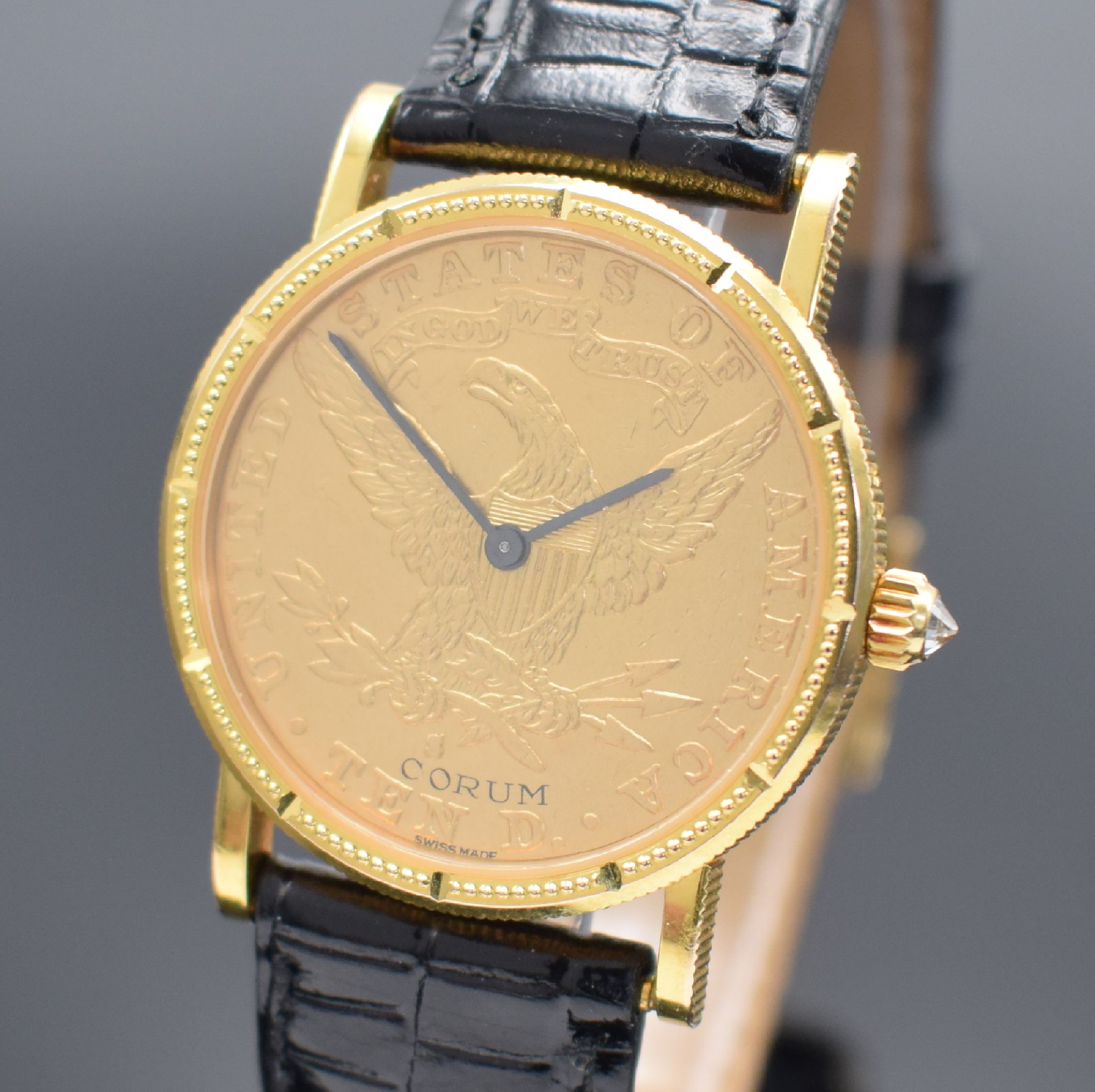 Detail a: CORUM Herrenarmbanduhr in Form einer 10 US- Dollar Goldmünze von 1884, Handaufzug, Schweiz um 1976, massiv GG 750/000 inkl. Lederband m. orig. ...