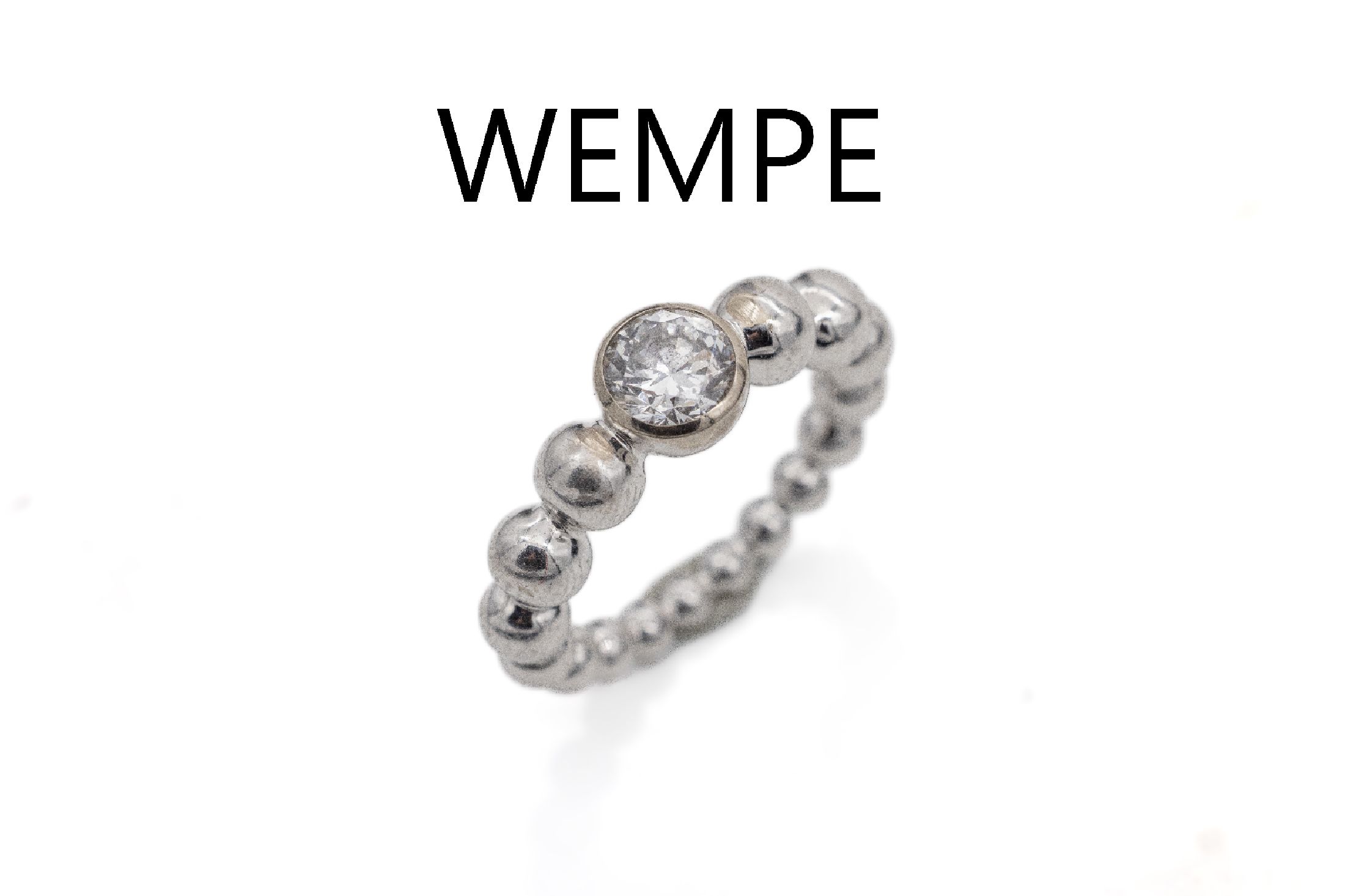 18 kt Gold WEMPE Brillant-Ring, WG 750/000,außergewöhnliche Gestaltung, Ringschiene aus Kugeln im Verlauf, einzelner Brillant ca. 0.91ct ...