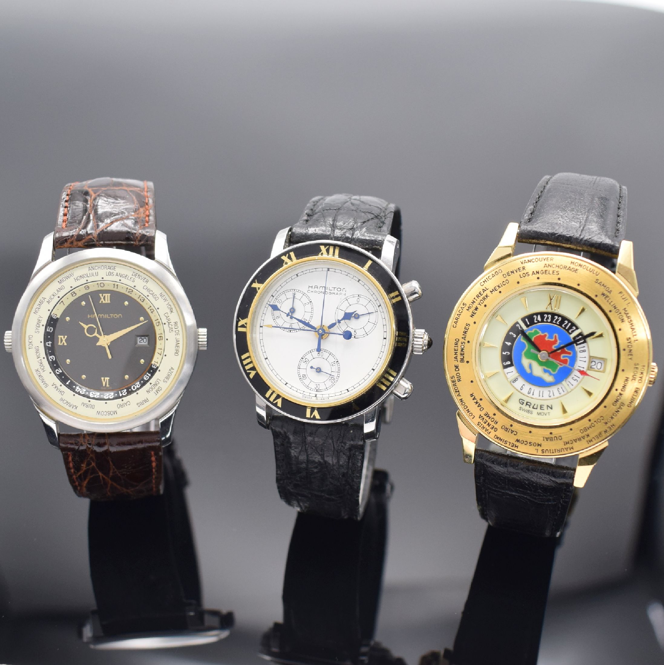 3 Herrenarmbanduhren mit Quarz-Werken, 1) Hamilton in Stahl mit Weltzeit-Anzeige, D. ca. 38 mm, EZ 2, 2) Hamilton Chronograph in Stahl, D. ca. 36 mm, ...