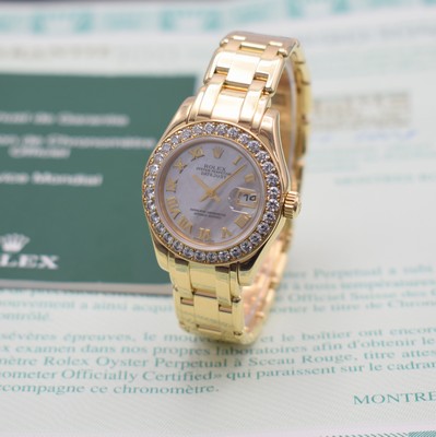 Image ROLEX 18k yellow gold ladies wristwatch Oyster Perpetual Datejust Pearlmaster, self winding, reference 80298, P-series, superlative chronometer officially certified, screwed-down case back & winding crown, factory diamonds set bezel, Pearlmaster bracelet with deployant clasp, mother of pearl dial with Roman numerals, gilded hands, date, diameter approx. 29 mm, length approx. 17 cm, original certificate enclosed, condition 2