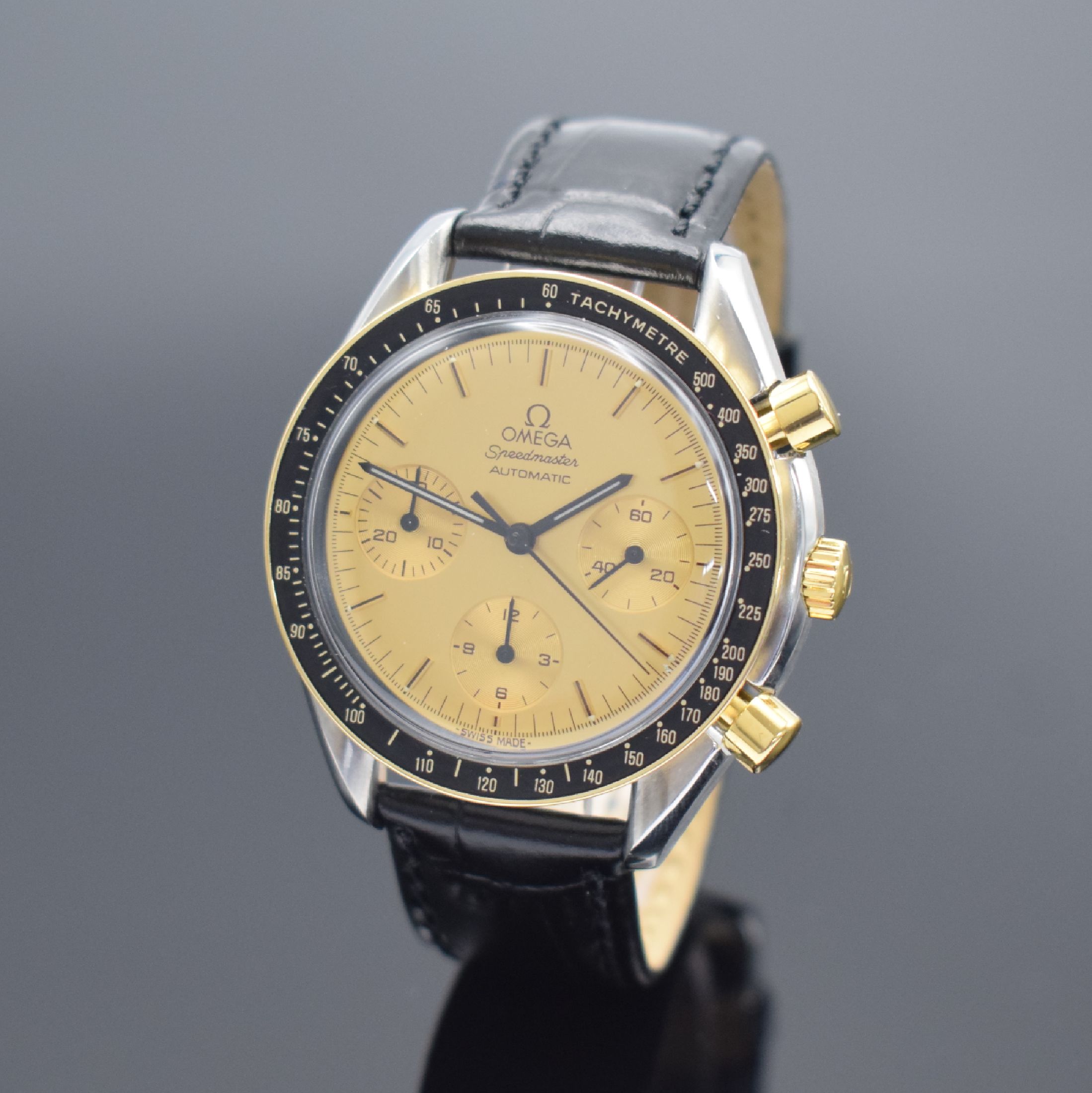 OMEGA Speedmaster Herrenchronograph in Stahl/Gold Referenz 175.0032, Schweiz um 1990, Automatik, Lünette m. Tachymeterskala, goldfarb. Zifferbl. m. ...