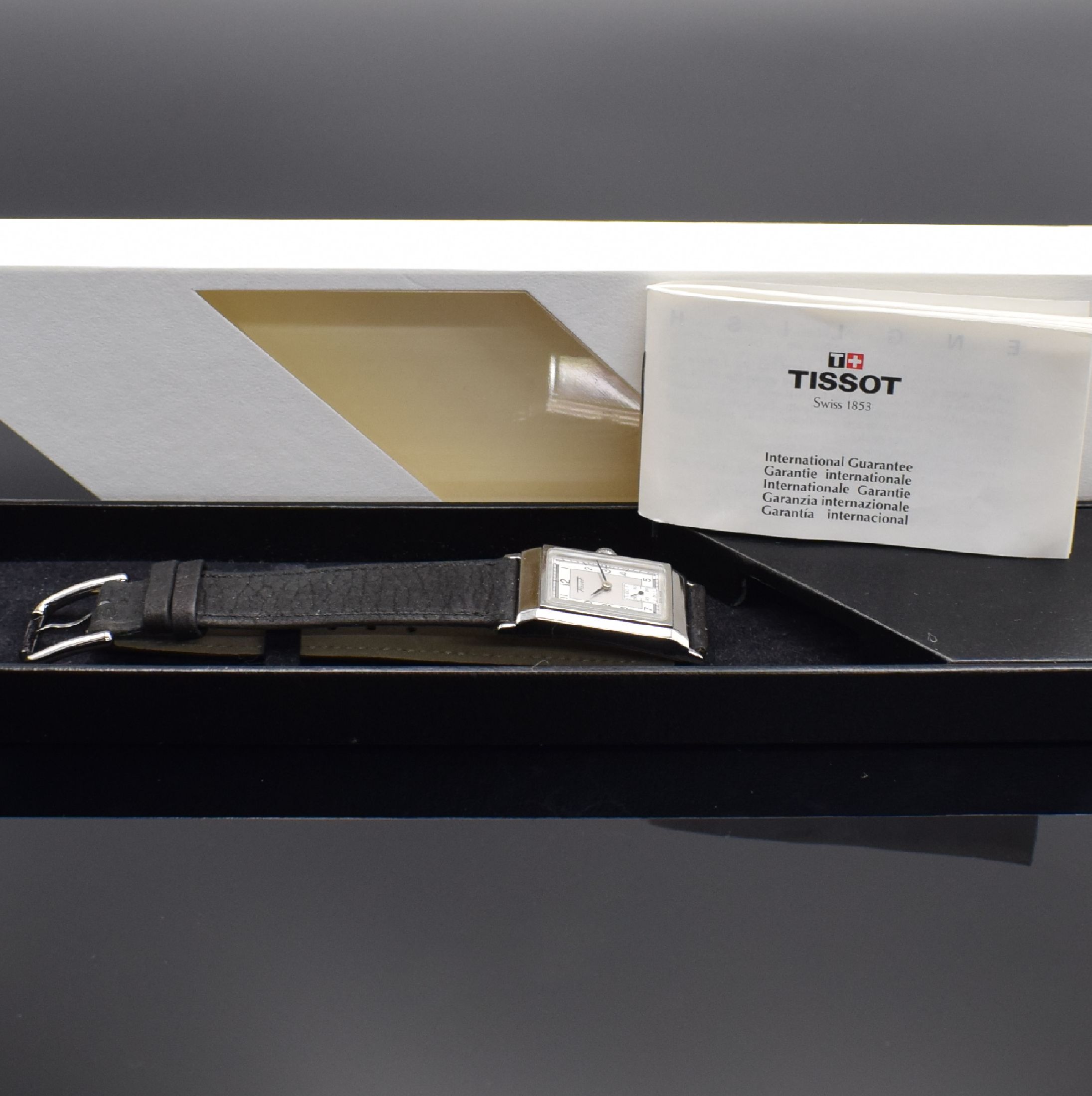 Detail e: TISSOT rechteckige Armbanduhr in Stahl, Schweiz verk. lt. beil. Garantie 12/1995, quarz, Boden 4-fach verschr., orig. Lederband m. Dornschl., silb. ...