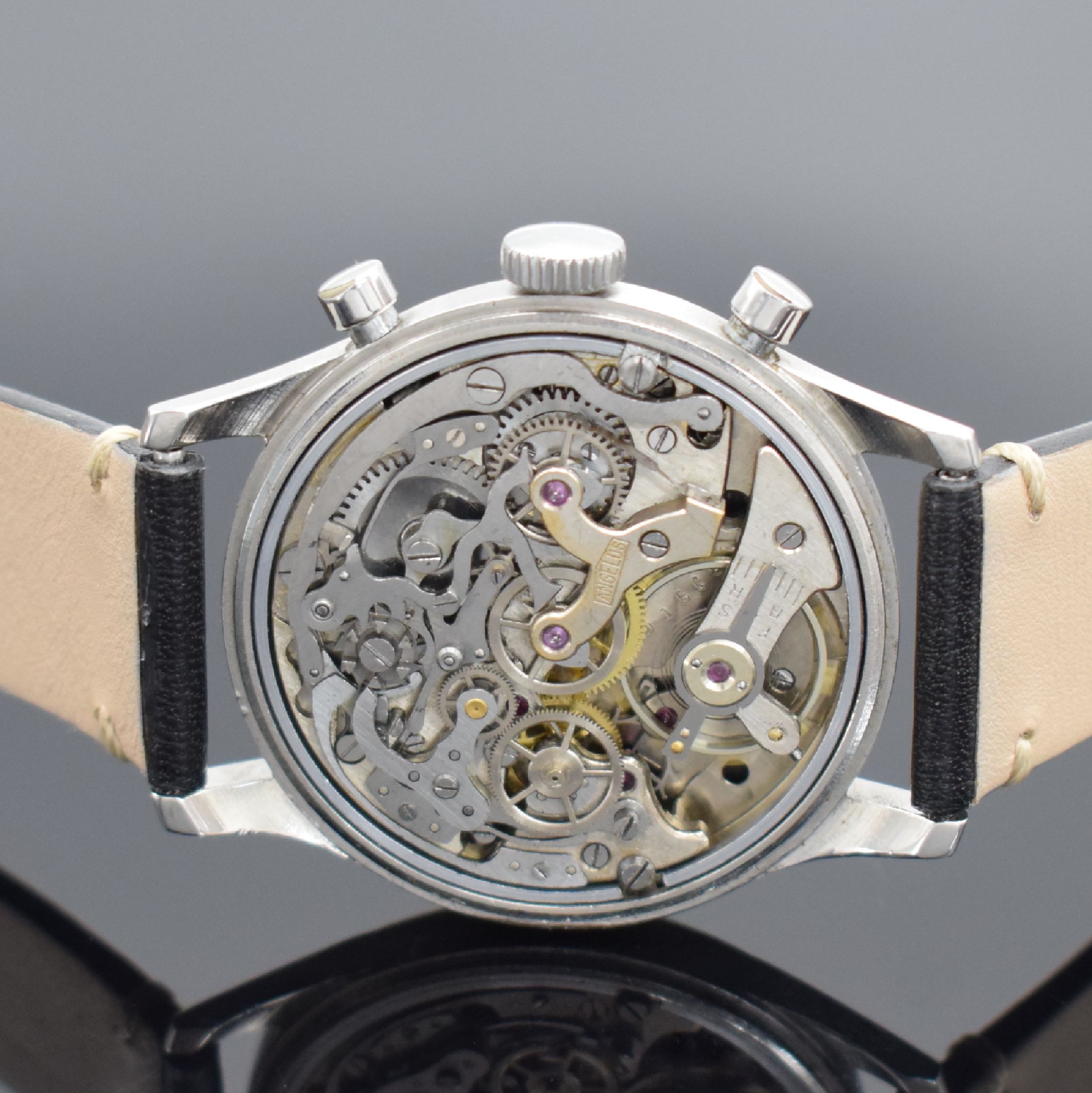 Detail d: ANGELUS Herrenchronograph mit Schaltrad in Stahl, Schweiz um 1945, Handaufzug, Boden aufgedr., schwarzes Zifferbl. rest., arab. Leuchtzahlen, ...
