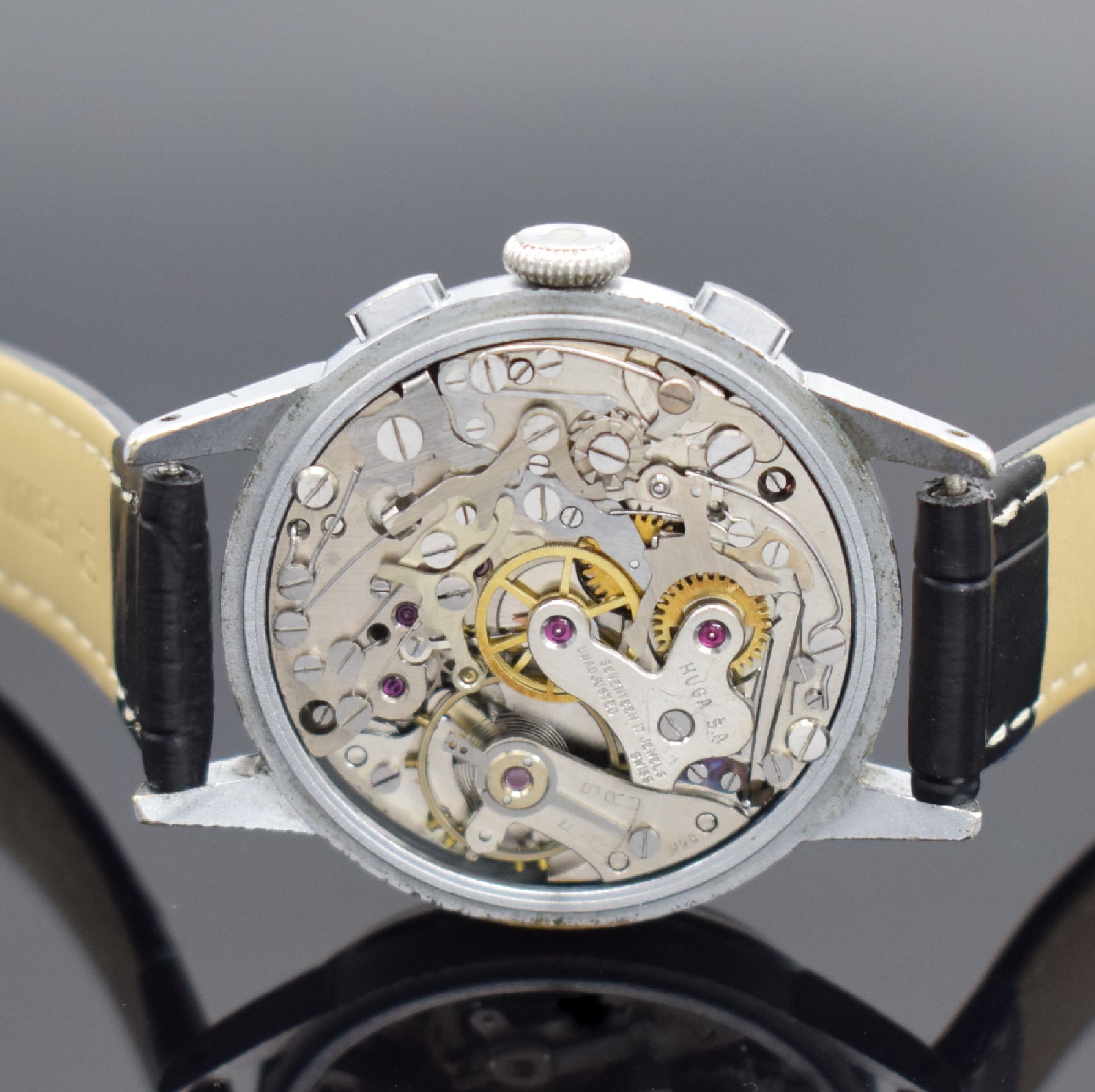 Detail d: HUGEX Herrenchronograph mit Schaltrad, Schweiz um 1950, Handaufzug, verchr. Geh., Stahlboden aufgedr., silb. Zifferbl. fl., arab. Leuchtzahlen, gebl. ...