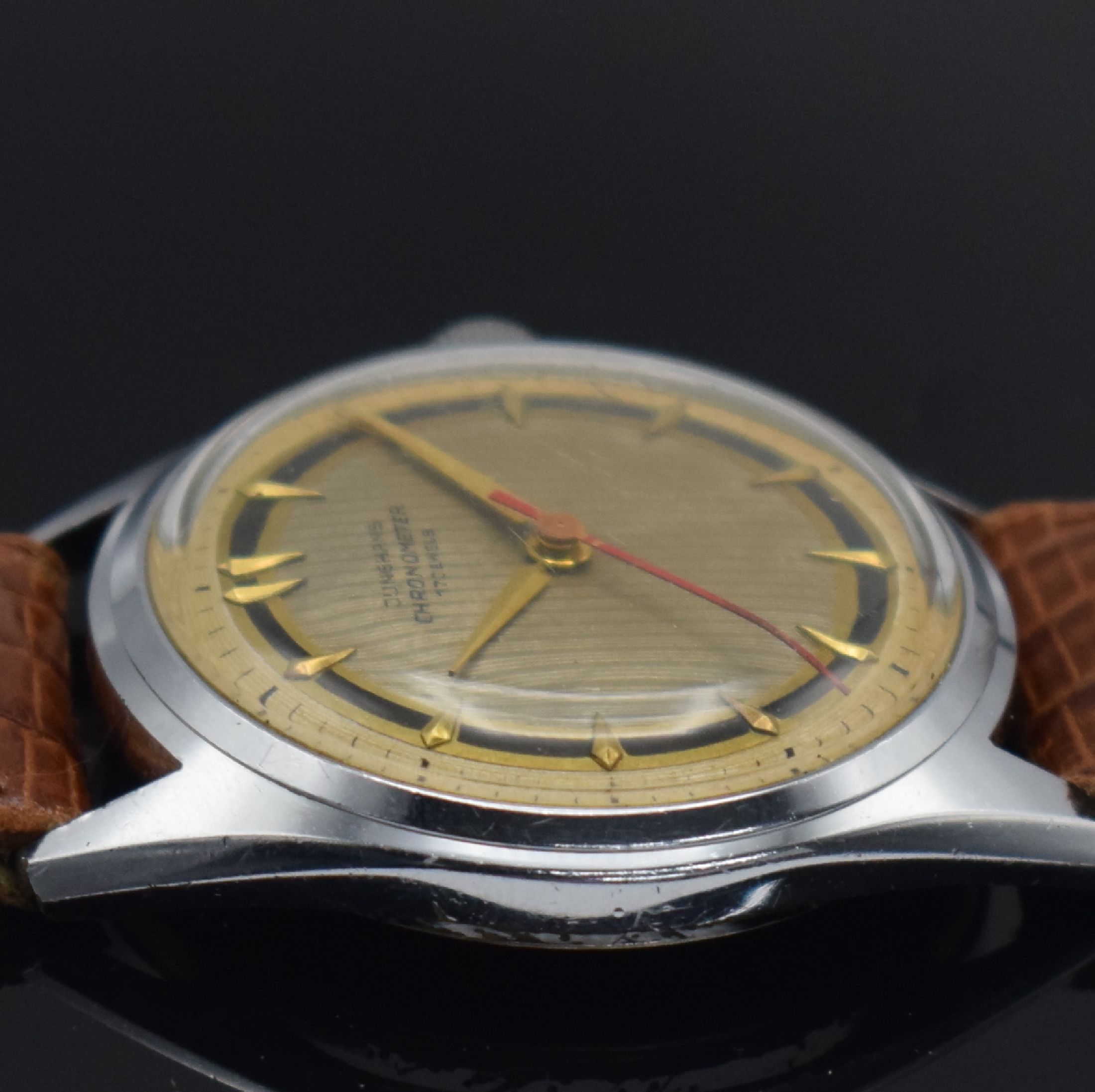 Detail e: JUNGHANS Chronometer Herrenarmbanduhr mit Kaliber 82/1, Deutschland um 1954, Handaufzug, verchr. Geh., Stahlboden geschr., schönes mehrfarb. ...
