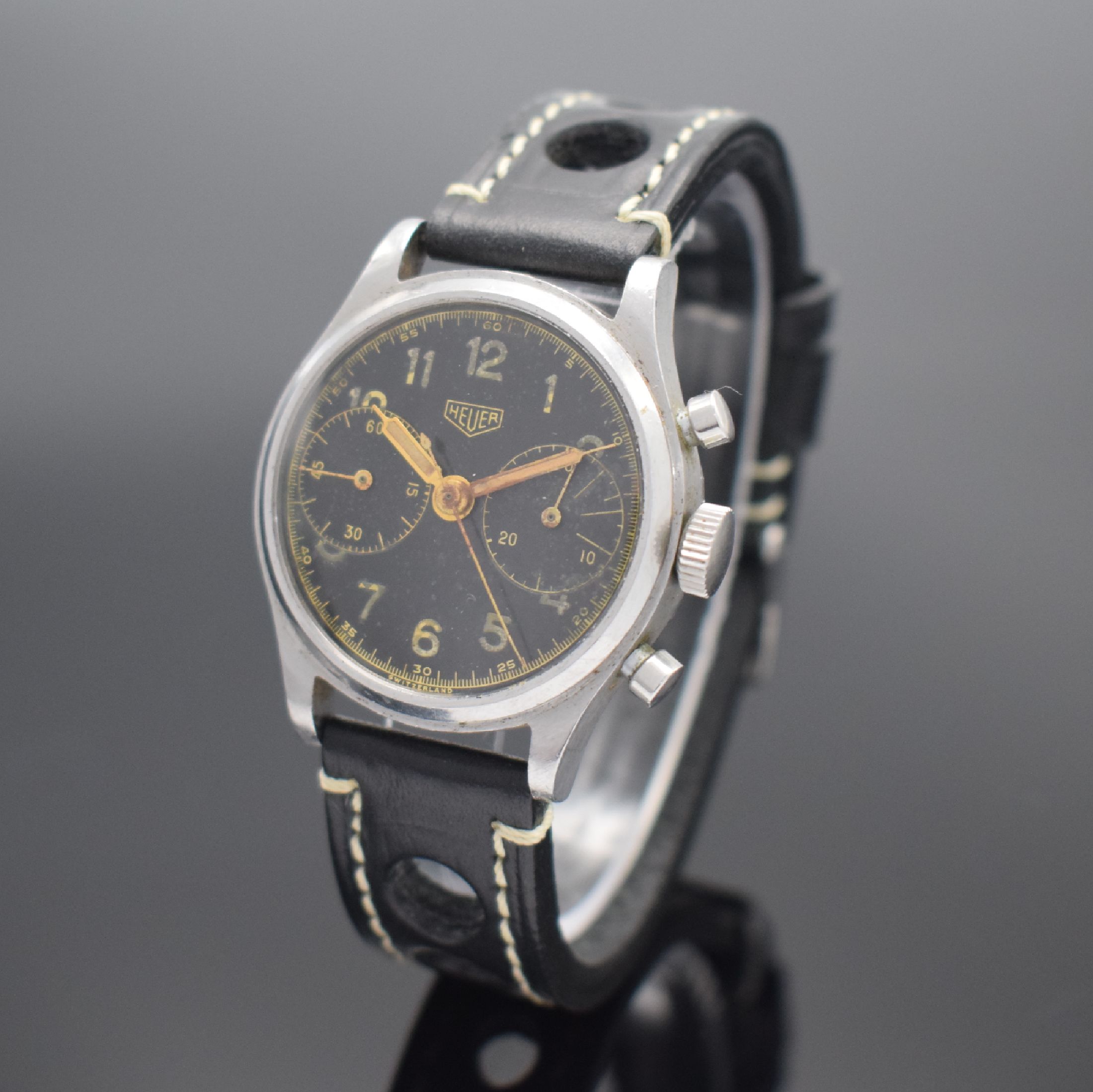 HEUER seltener Schaltradchronograph mit Kaliber Valjoux 23 in Edelstahl, Schweiz um 1950, Handaufzug, sign. Boden geschr., schwarzes orig. ...