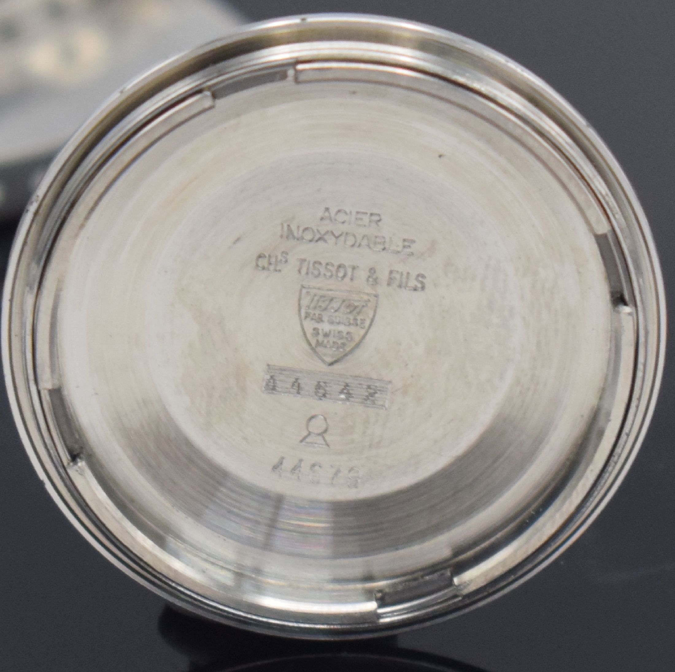 Detail j: TISSOT T12 Herrenarmbanduhr mit geschraubtem Boden, Schweiz um 1970, Automatik, massives Stahlgeh. m. sign. Boden & Seefahrtsymbolik, orig. ...