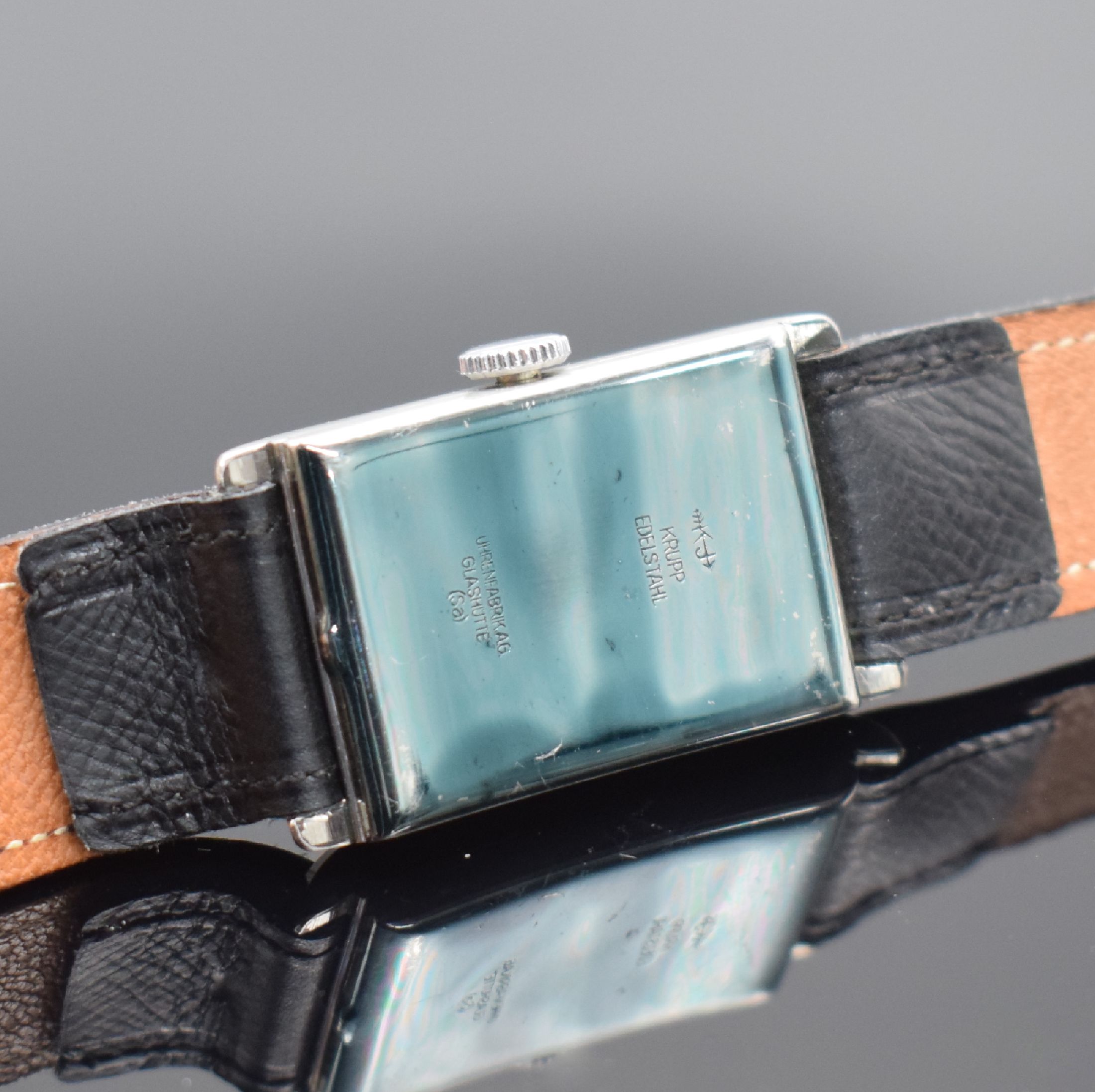 Detail c: TUTIMA Glashütte / UROFA 58 rechteckige Lagerbestand-Armbanduhr in Stahl, Deutschland um 1935, Scharniergeh. m. Schutzlack auf dem Boden, orig. Band ...