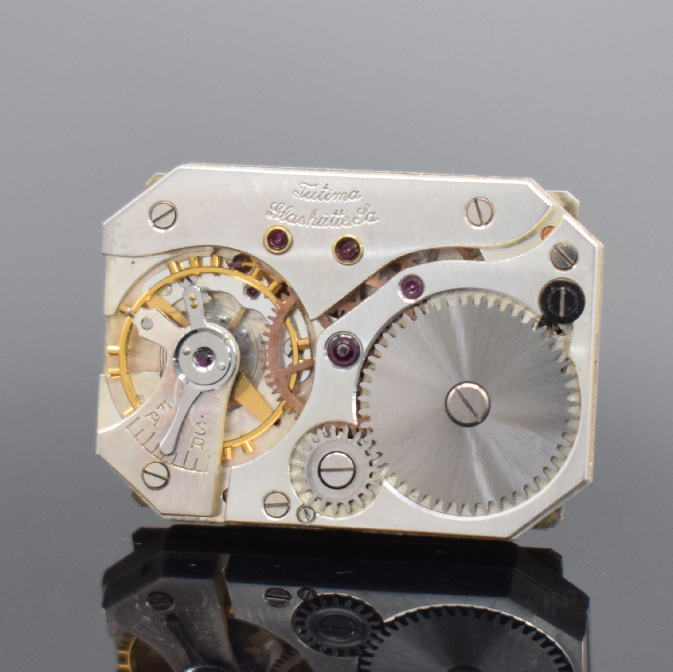 Detail e: TUTIMA Glashütte / UROFA 58 rechteckige Lagerbestand-Armbanduhr in Stahl, Deutschland um 1935, Scharniergeh. m. Schutzlack auf dem Boden, orig. Band ...