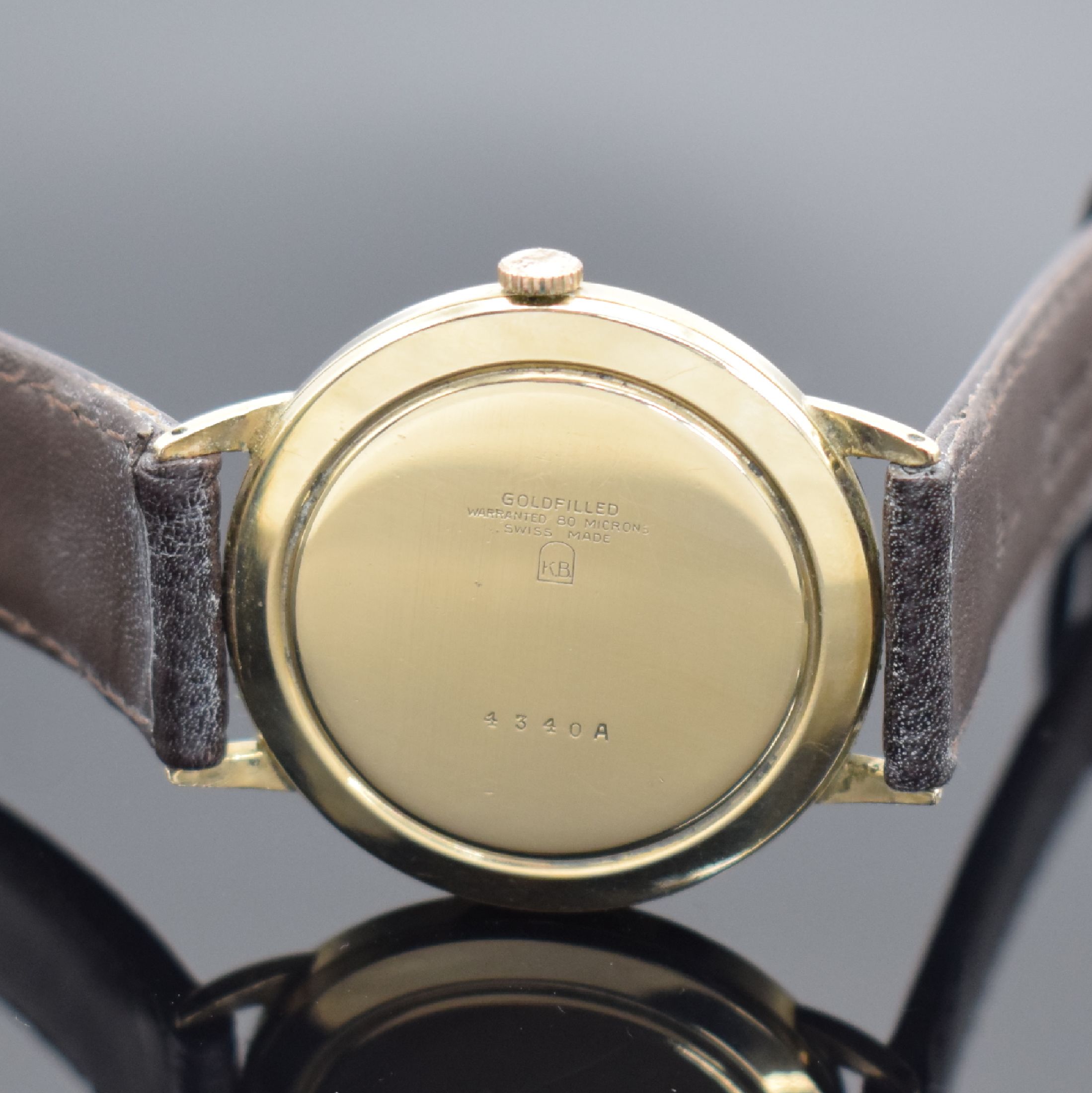 Detail c: RODANA De Luxe gold filled Herrenarmbanduhr, Schweiz um 1960, Handaufzug, Boden aufgedr., silb. Zifferbl. pat./fl., gold. Std.-Ind. & arab. Zahlen, ...