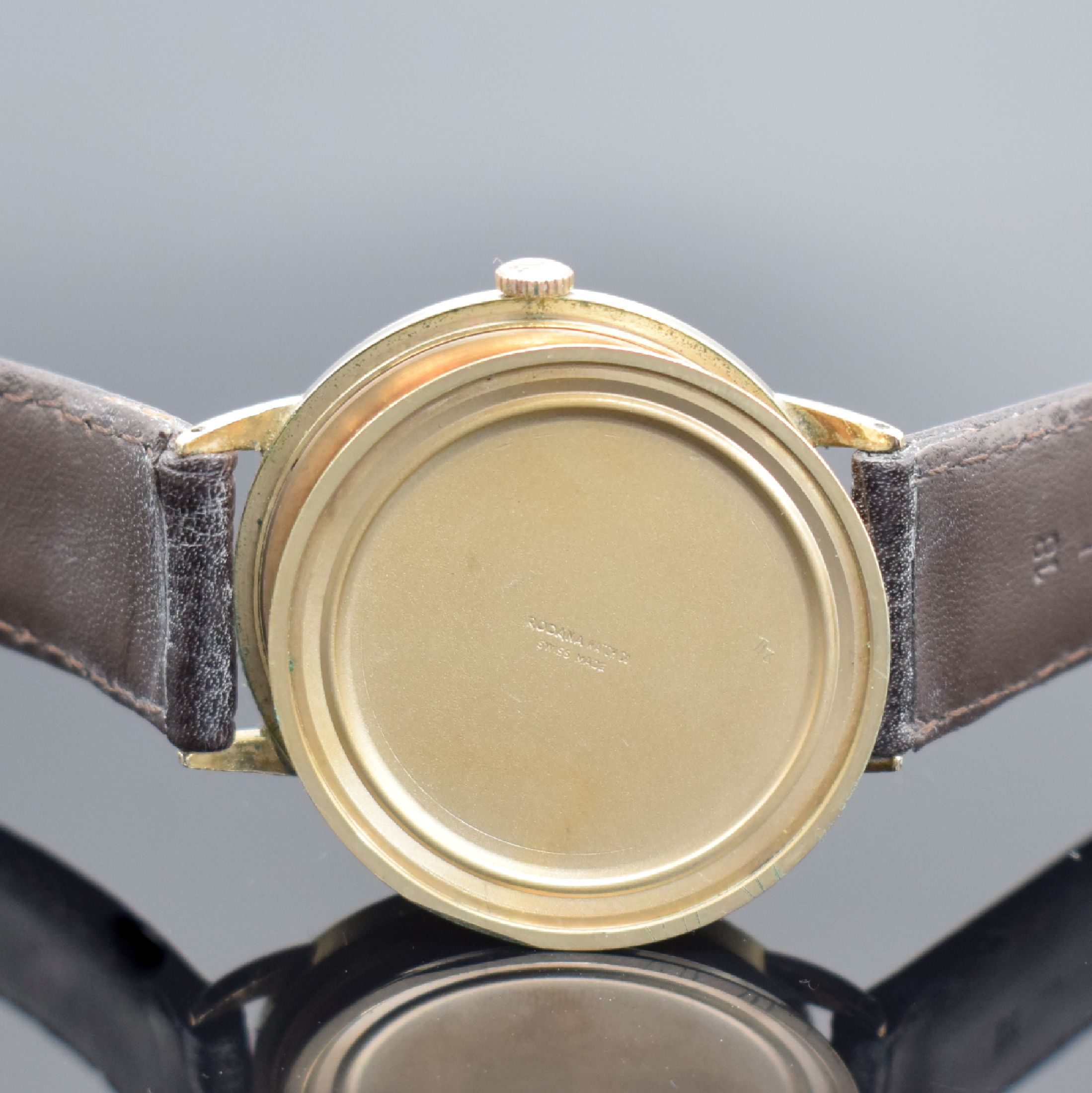 Detail e: RODANA De Luxe gold filled Herrenarmbanduhr, Schweiz um 1960, Handaufzug, Boden aufgedr., silb. Zifferbl. pat./fl., gold. Std.-Ind. & arab. Zahlen, ...
