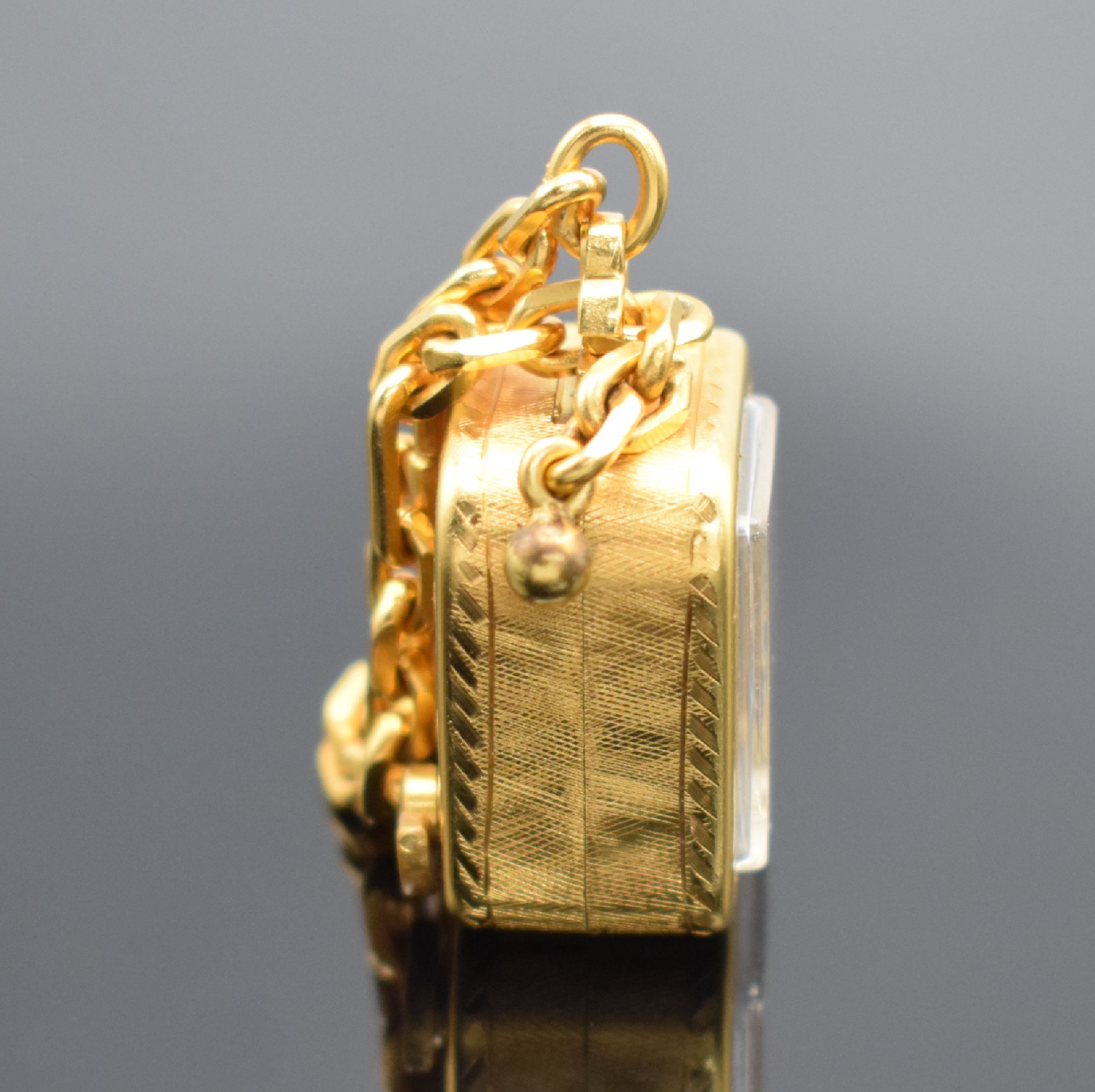 Detail a: REUGE Miniaturspieluhr an Kette, Schweiz um 1960, Handaufzug, verg. strukt. Geh., gedr., vorderseitig einges. Uhr, silb. Zifferbl. m. gold. Zeiger & ...
