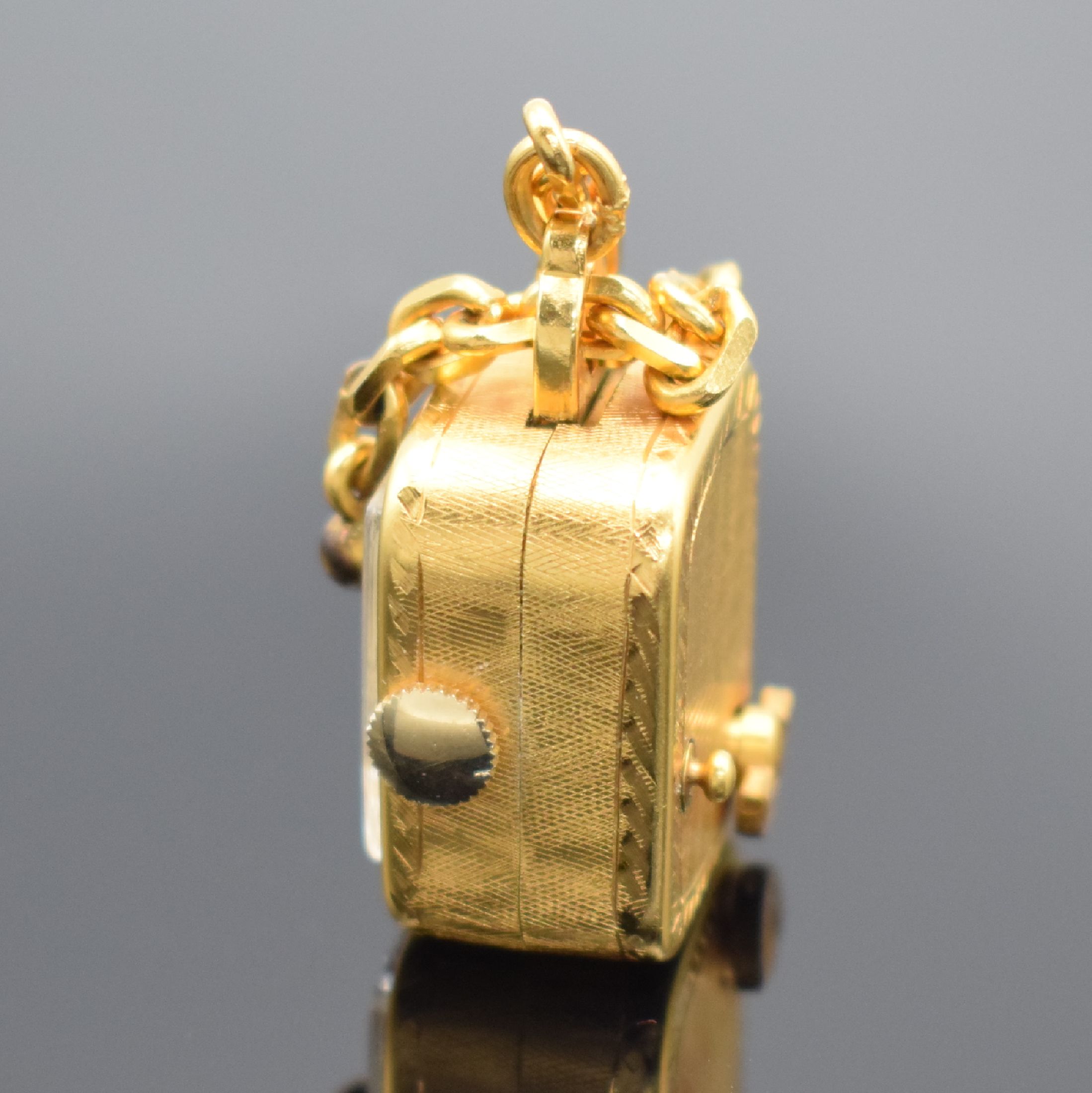 Detail c: REUGE Miniaturspieluhr an Kette, Schweiz um 1960, Handaufzug, verg. strukt. Geh., gedr., vorderseitig einges. Uhr, silb. Zifferbl. m. gold. Zeiger & ...