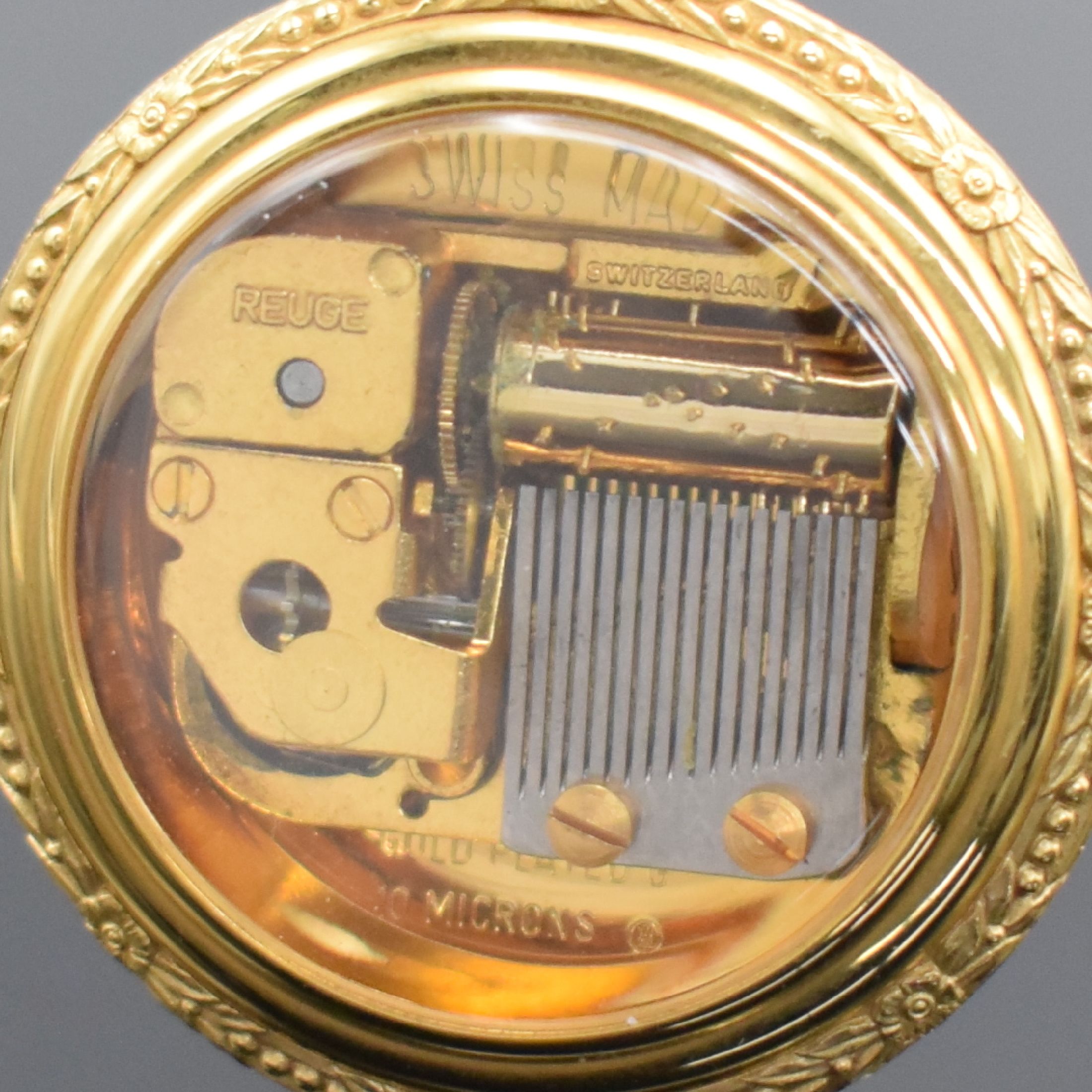 Detail a: REUGE vergoldete Miniaturspieluhr, Schweiz um 1980, Melodie "Eine kleine Nachtmusik", Geh. floral verz., front durchs., rücks. Aktivierung ...