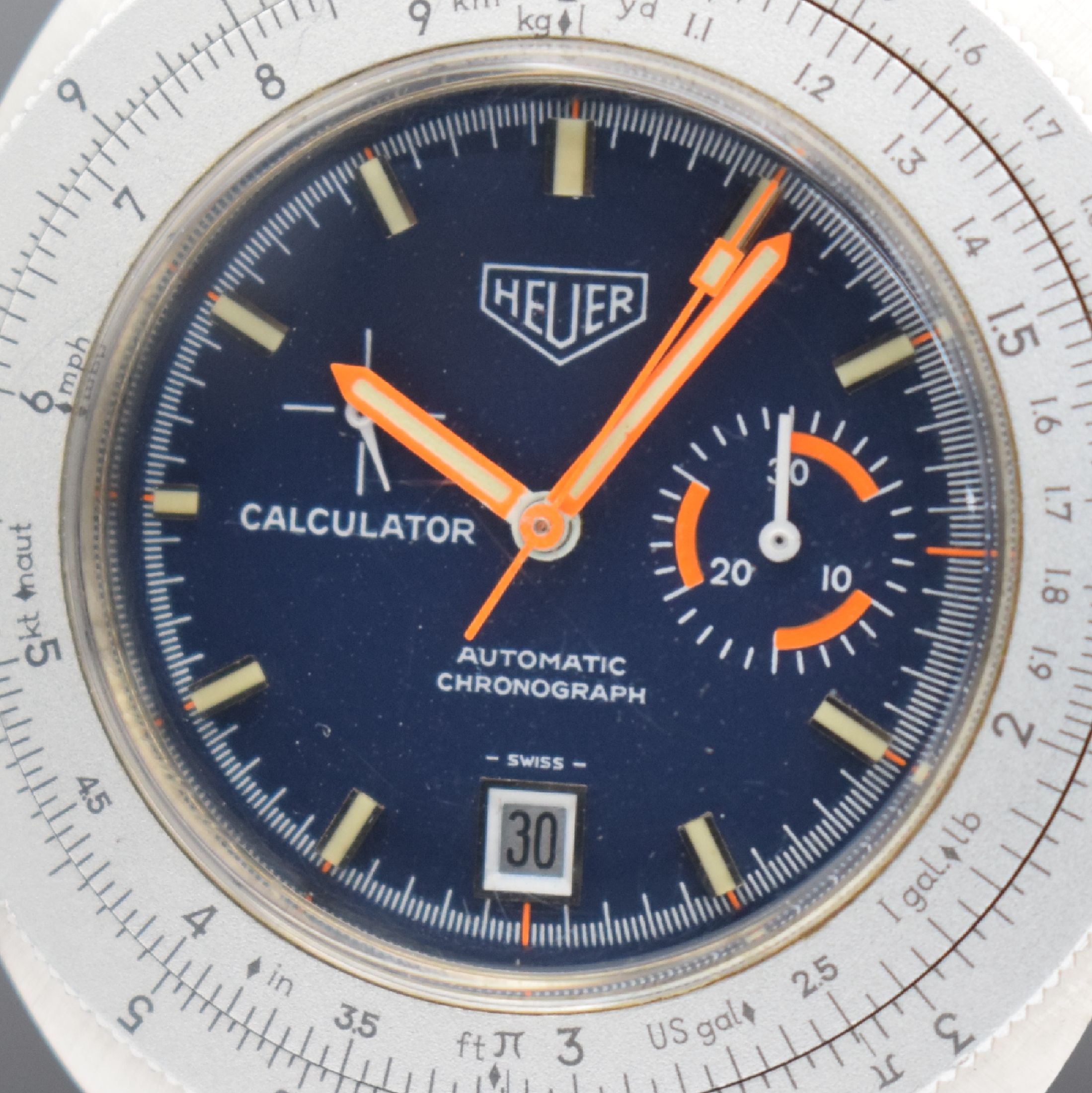 Detail a: HEUER Calculator Herrenchronograph in Stahl Referenz 150.633, Schweiz um 1975, Automatik, verschr. Geh. Aluminium Rechenschieber-Lünette, orig. ...