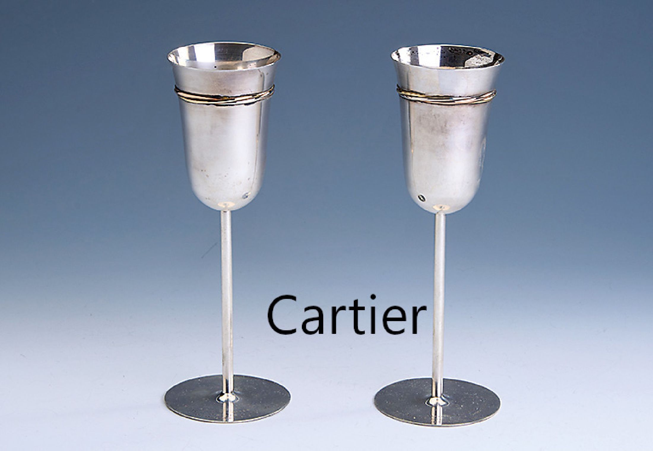 2 CARTIER Champagnerkelche, 925er Silber, Frankreich, Paris um 1979, aus der Trinity -Serie, schlichte Gestaltung, tricolor Zierband, H. ca. 21 cm, ...