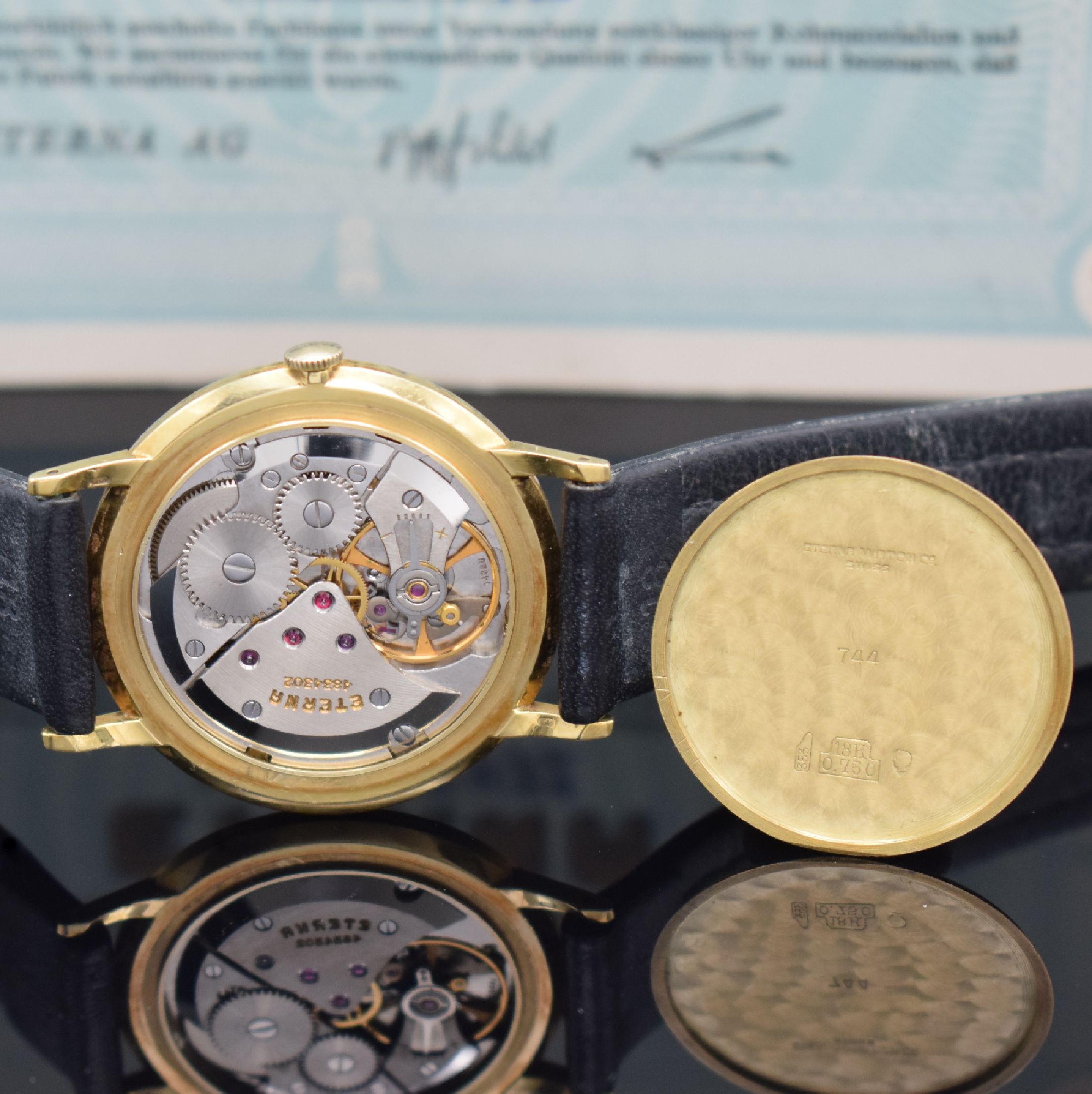 Detail h: ETERNA Herrenarmbanduhr in GG 750/000 mit original Papier Referenz 744, Schweiz verk. lt. Papier 1964, Handaufzug, flaches Geh., Boden & Glasrand ...