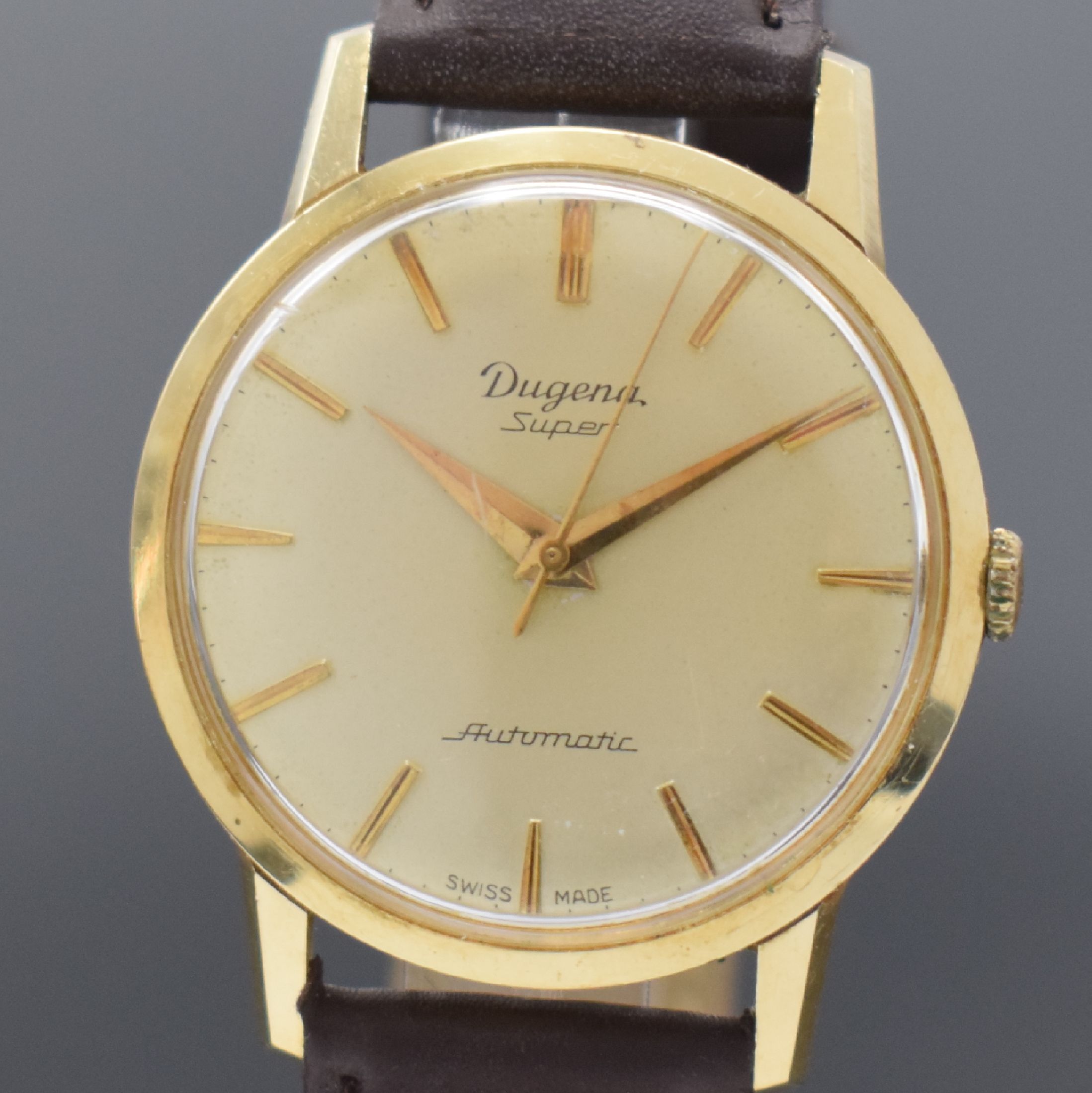 Detail a: DUGENA Herrengolduhr Modell Super in GG 585/000, Schweiz um 1960, Automatik, Geh. teils angel., Boden & Glasrand aufgedr., vers. Zifferbl. altersbed. ...