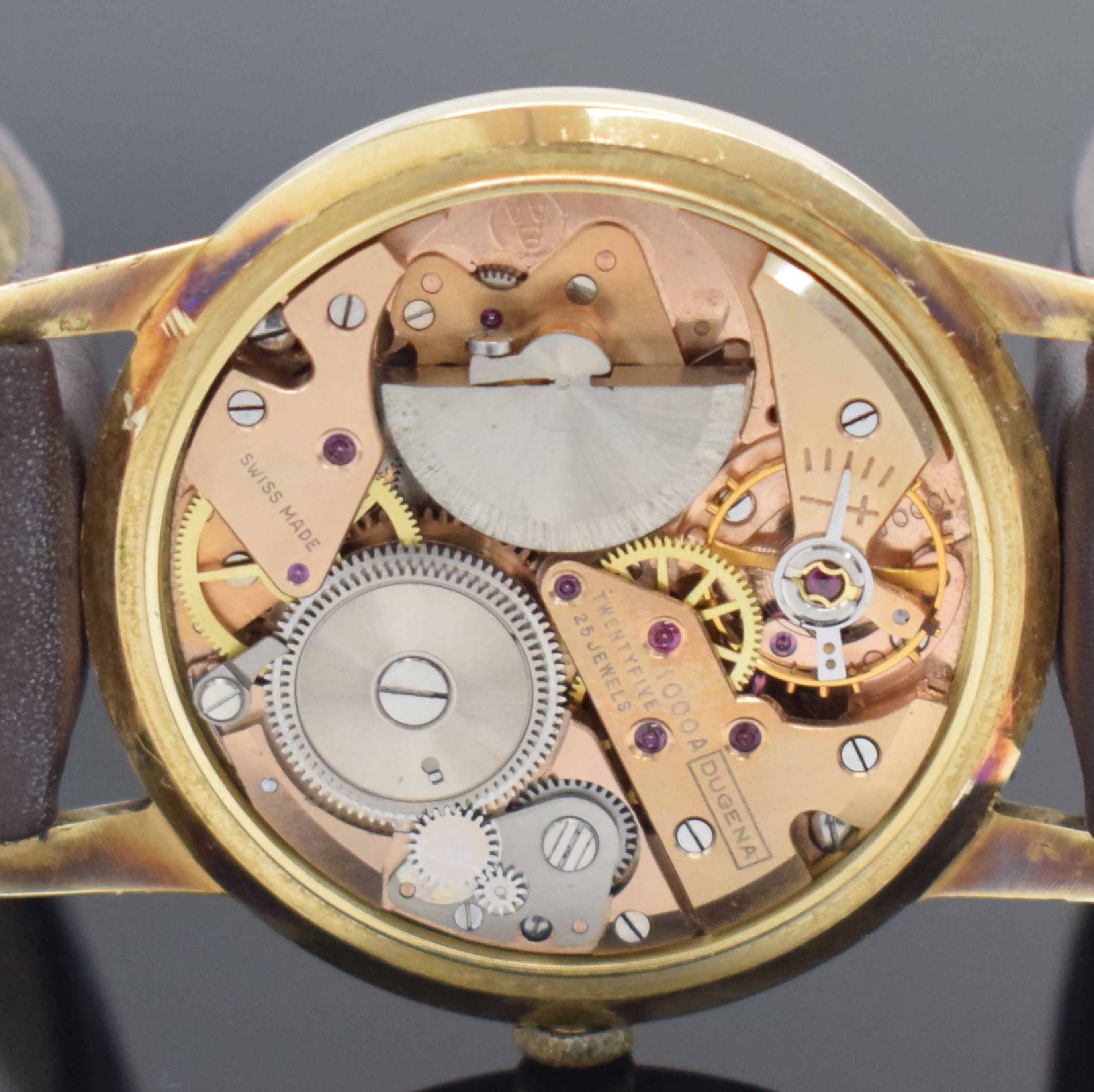 Detail e: DUGENA Herrengolduhr Modell Super in GG 585/000, Schweiz um 1960, Automatik, Geh. teils angel., Boden & Glasrand aufgedr., vers. Zifferbl. altersbed. ...