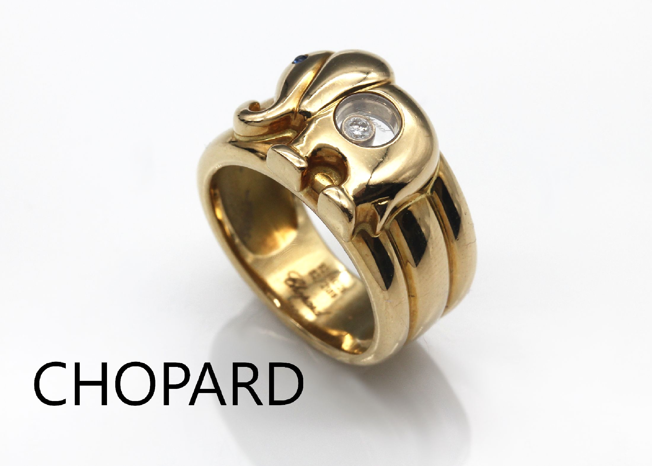 18 kt Gold CHOPARD Ring "Elefant", GG 750/000, Serie Happy Diamond, rundfacett. Saphir als Auge ca. 0.01 ct, 1 Brillant bewegl. unter Glas ...