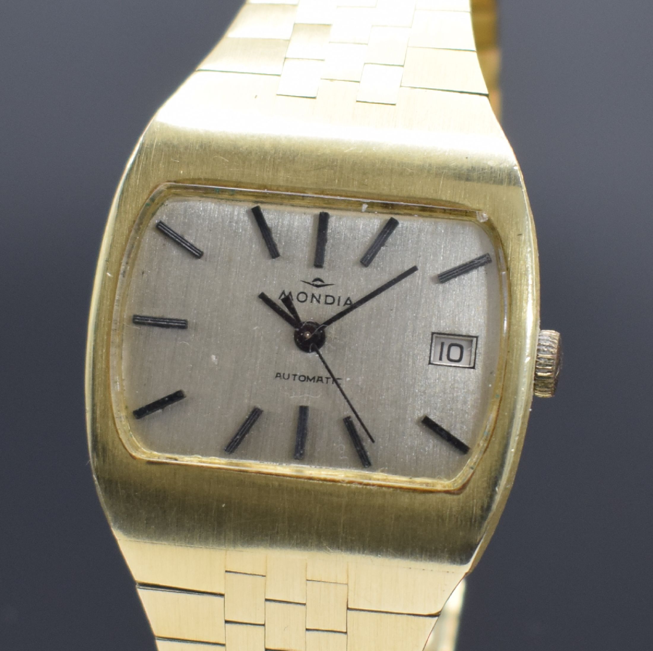 Detail a: MONDIA Herrenarmbanduhr in GG 585/000, Schweiz um 1970, Automatik, Boden aufgedr., silb. Zifferbl. m. aufgel. Std.-Ind., schwarze Zeiger, Datum b. 3, ...