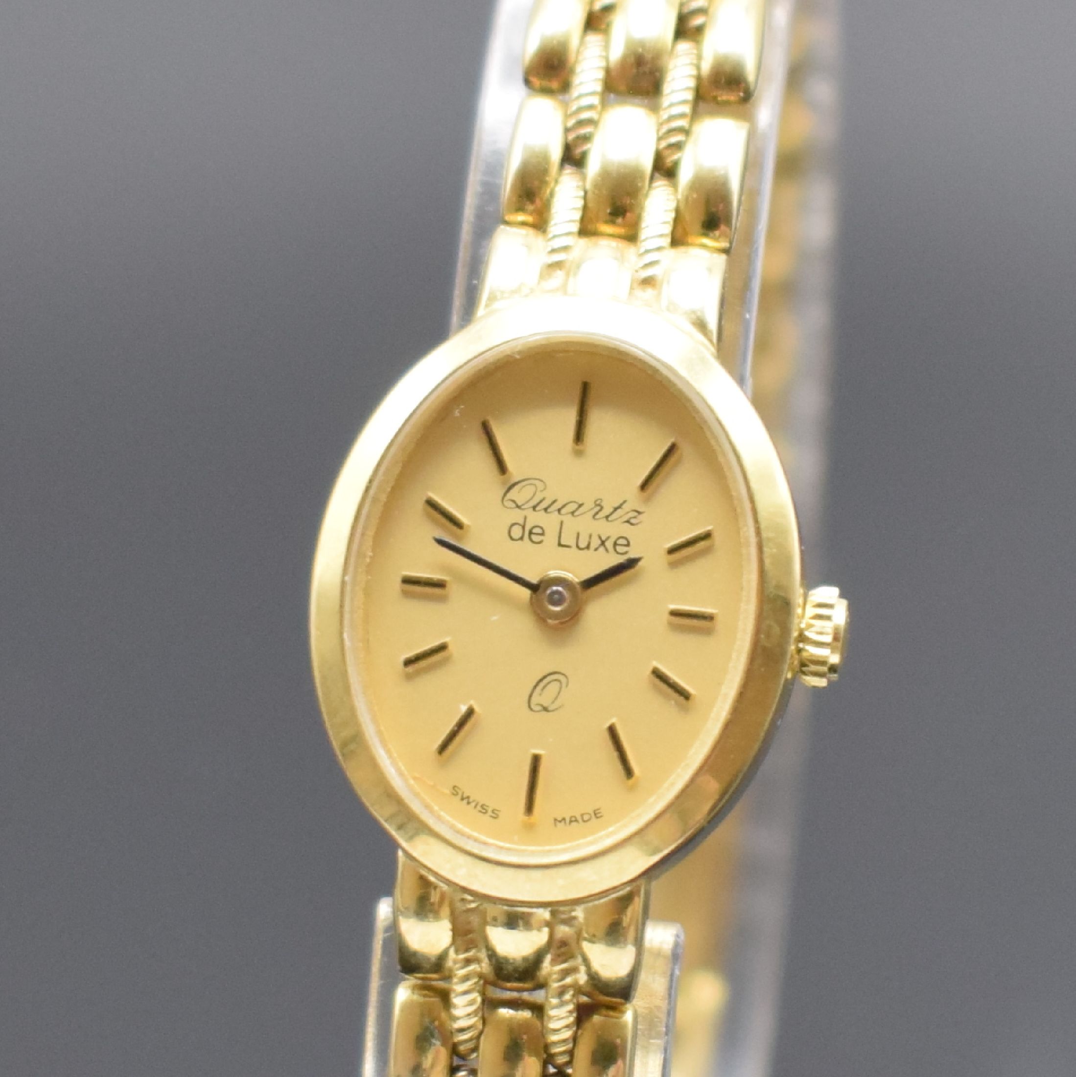 Detail a: DE LUXE Quartz Damenarmbanduhr in GG 333/000, Schweiz um 2000, Geh. an Goldband 333/000, Boden aufgedr., champagnerfarb. Zifferbl. m. gold. ...