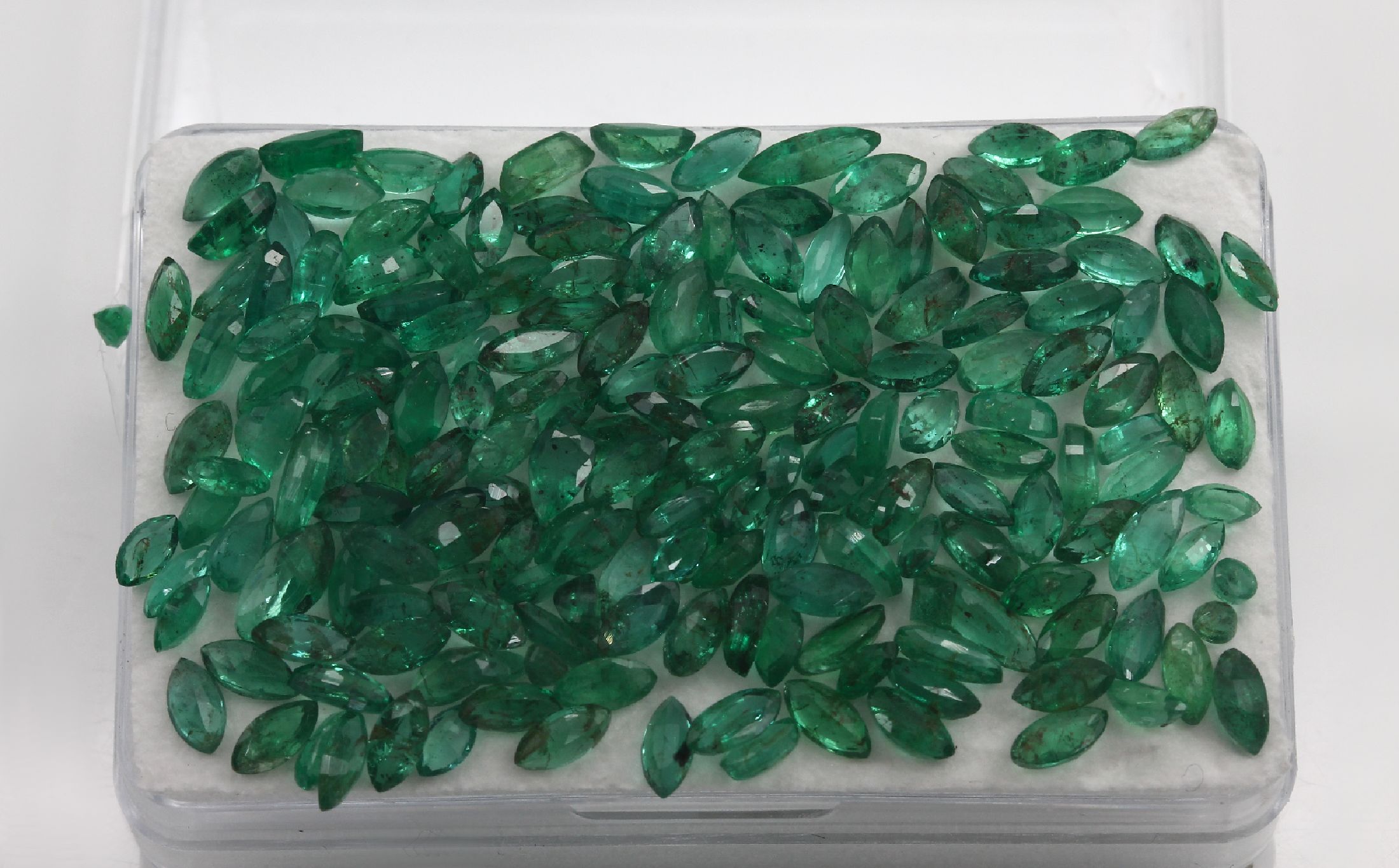 Detail a: Lot lose Smaragde zus. ca. 33.07 ct, überwiegend Navette-Schliff, nat. Merkmale