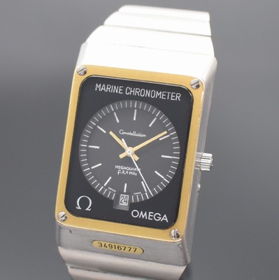 26538720a - OMEGA wristwatch Constellation Megaquartz f2,4MHz Marine Chronometer, reference 198.0082/398.0832, solid stainless steel including stainless steel bracelet with deployant clasp, case back screwed-down 4- times, correction at the sides outside 4, yellow gold-bezel, gray dial with white hour- indices, luminous hands, date at 6, measures approx. 49 x 33 mm, length approx. 20 cm, condition 2