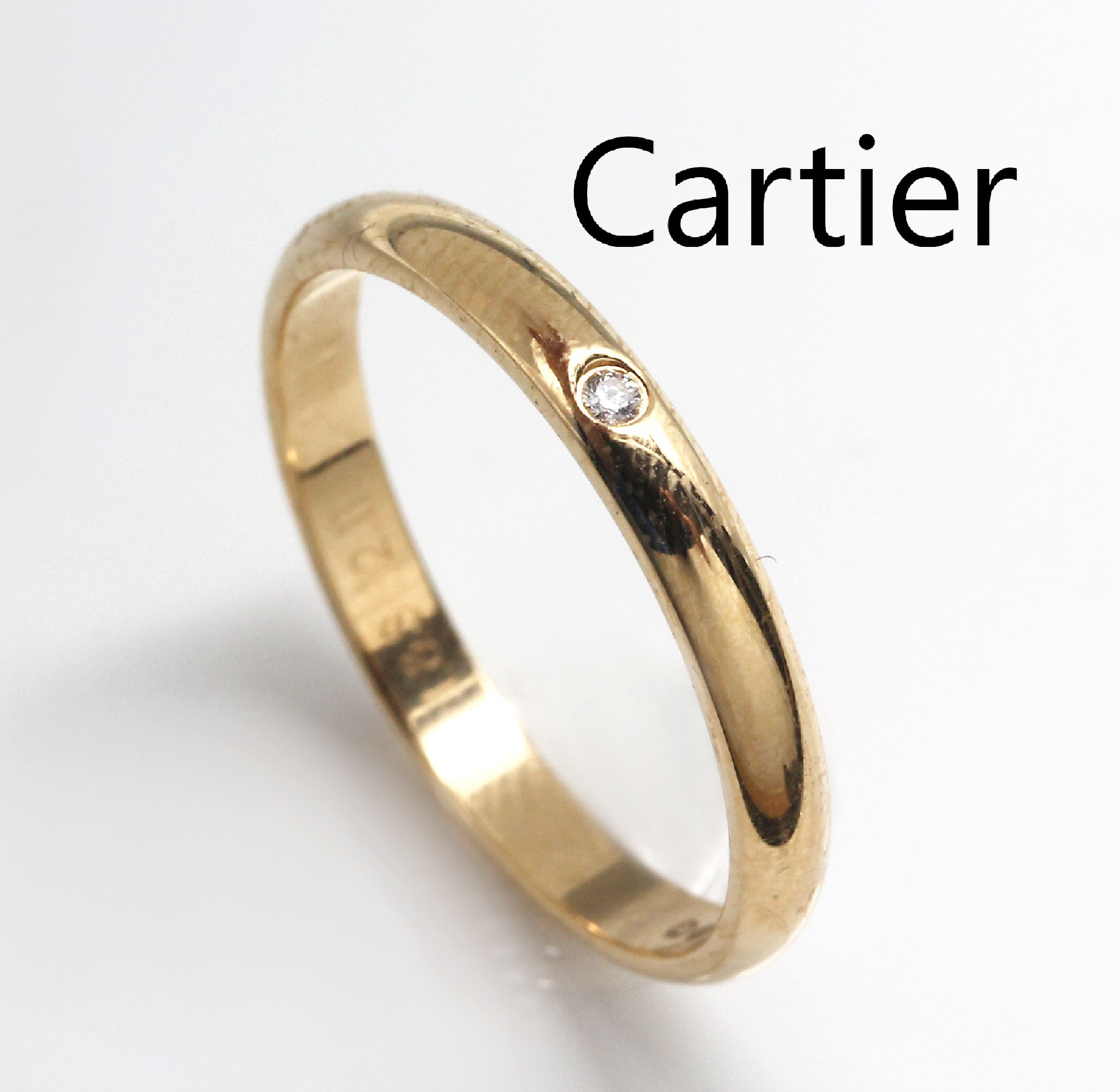 18 kt Gold CARTIER Ring, GG 750/000, mit kl. Diamant ca. 0.02 ct, RW 56, sign. und num., im Etui, Innen mit Gravur