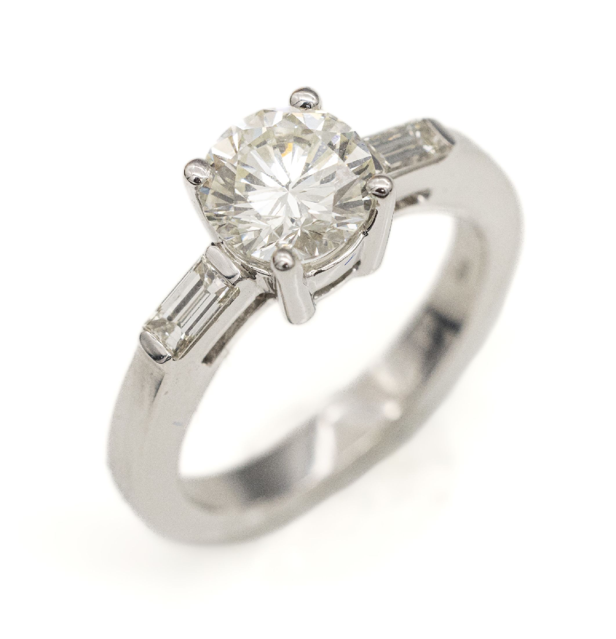 18 kt Gold Diamant-Ring, WG 750/000, mittigBrillant ca. 1.70 ct get.Weiß(K)/vs2, Ringschulter mit je einem Diamantbaguette zus.ca. 0.25 ct ...