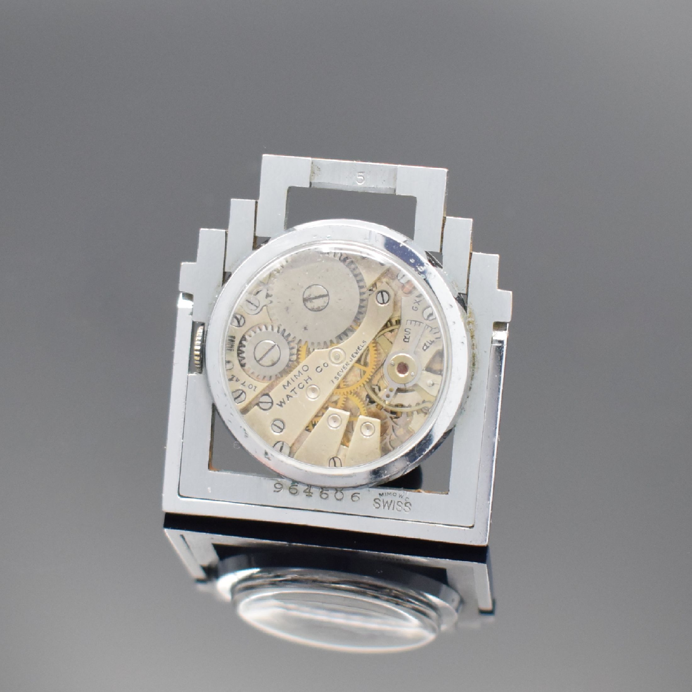 Detail c: MIMO Watch Co. kleine Reiseuhr, Schweiz um 1930, Handaufzug, aufstellbares, beidseitig vergl. Stahlgehäuse, teils verchr., schwarzes Zifferbl. m. ...
