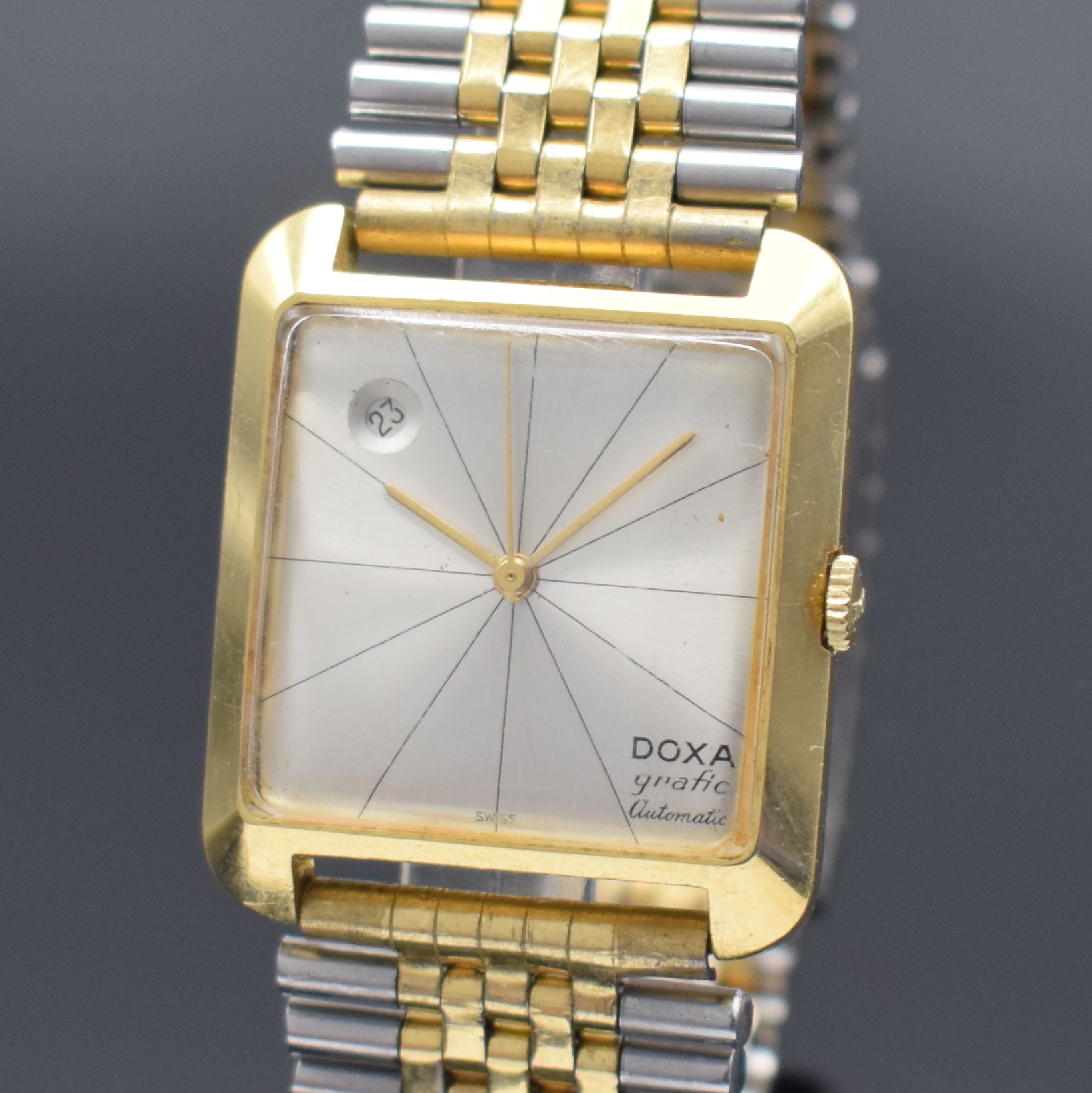 Detail a: DOXA Grafic Herrenarmbanduhr in GG 750/000, Schweiz um 1960, Automatik, 2-teil. Gehäuse, Boden aufgedr., neutr. Stahlbd. teils verg., silb. ...