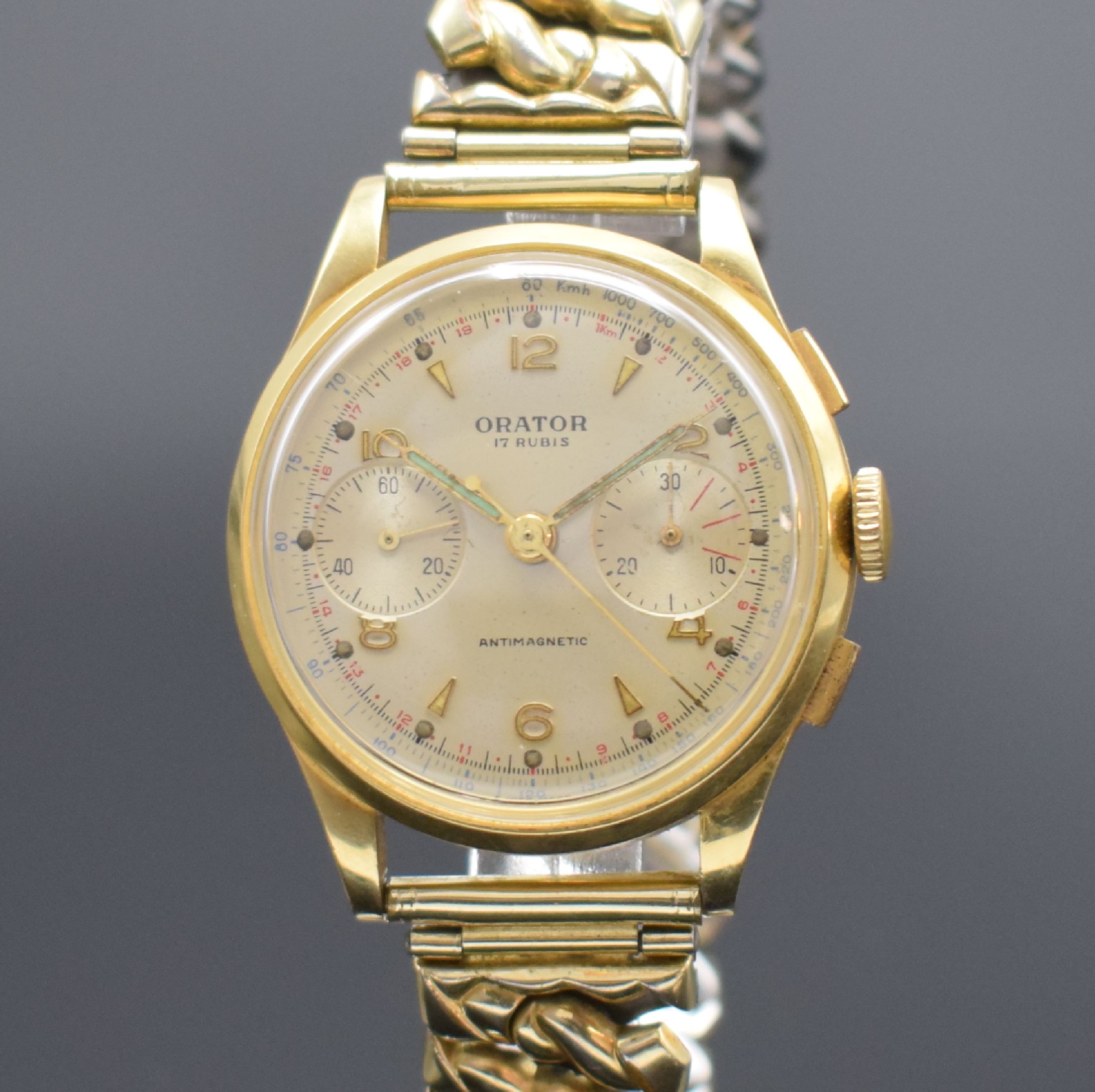 Detail a: ORATOR Herrenarmbanduhr mit Chronograph in GG 750/000, Schweiz um 1955, Handaufzug, 3- teil. Geh., Boden & Glasrand aufgedr., silb. Zifferbl. m. ...