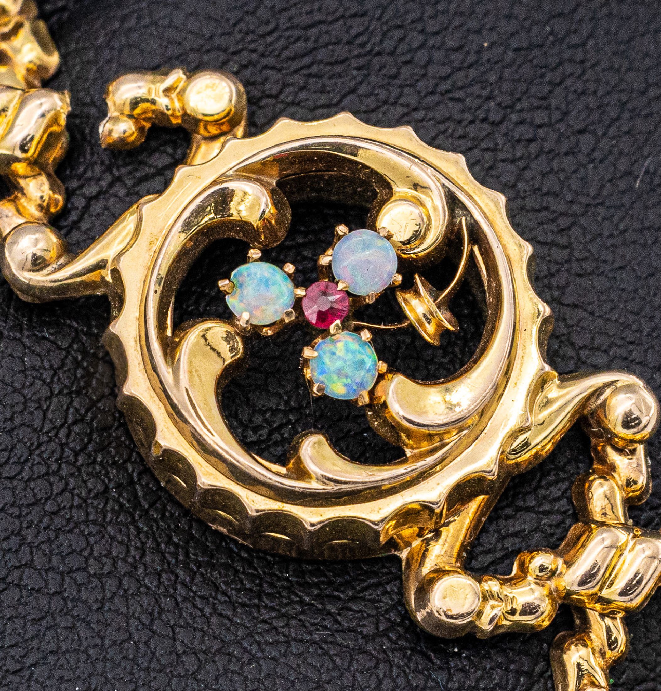 Detail a: 8 kt Gold Opal-Scherenarmband, wohl England um1890/1900, GG 333/000, rundes Mittelteil besetzt mit 3 Opalcabochons und roten Farbstein, D. max. 7.0 ...
