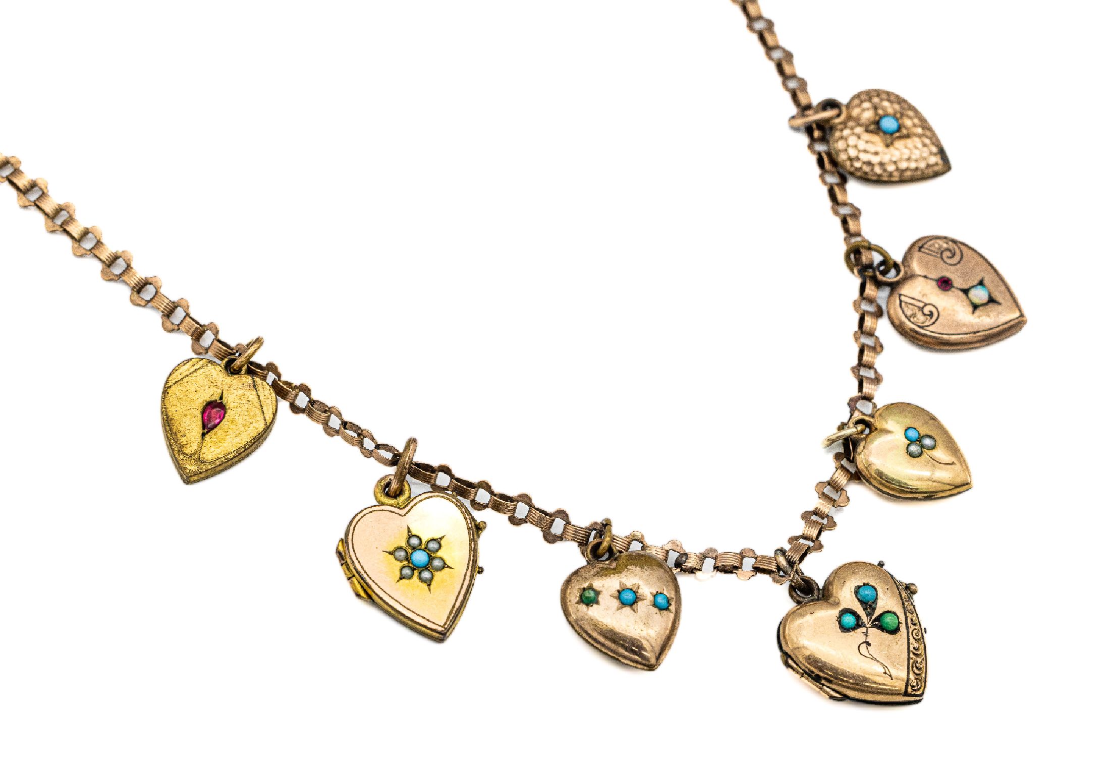 8 kt Gold Collier mit 7 Medaillon-Herz- Anhänger, 1910-1930, Anhänger Metall vergoldet mit div. Steinbesatz, L. ca. 41 cm, Federringschließe, ...