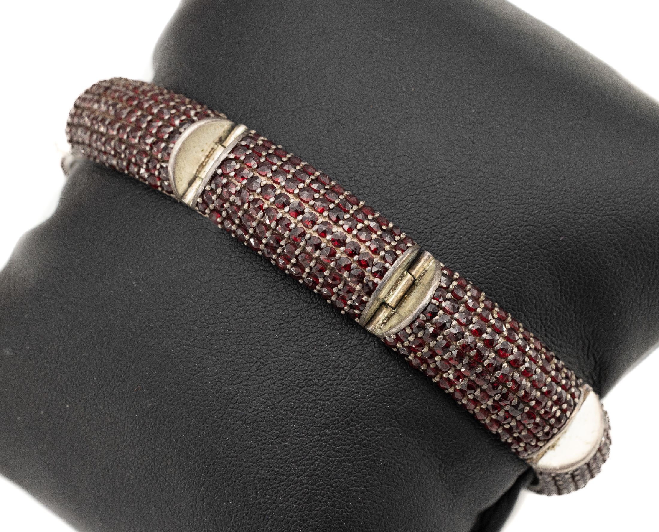 Armband mit Granaten, 800er Silber, Österreich 1930er Jahre, facett. Granaten, 7 Glieder mit jew. 7 Reihen Granaten besetzt, L. ca. 20 cm, total ...