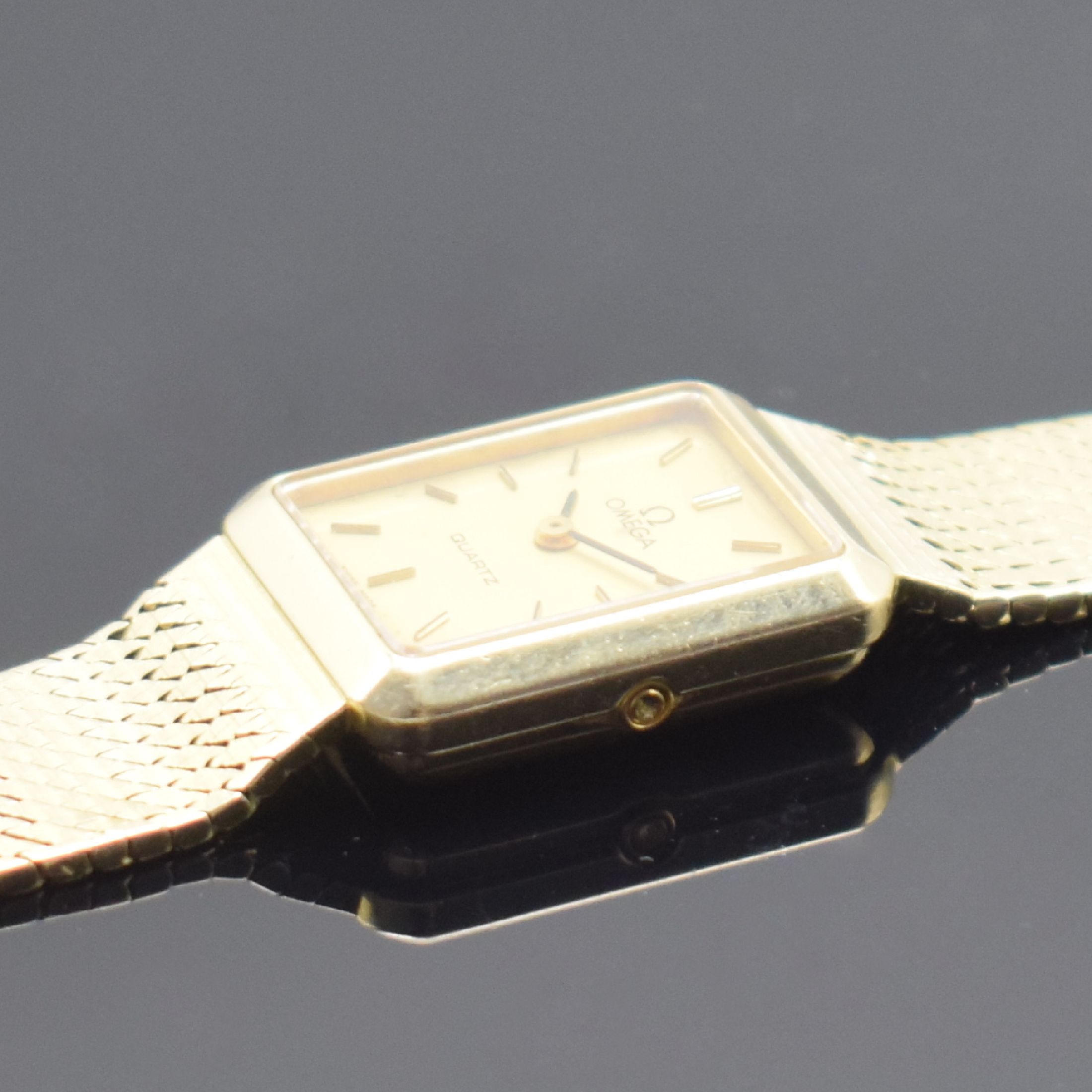Detail d: OMEGA Damenarmbanduhr in GG 585/000, Schweiz um 1980, quarz, 2-teil. Geh., Boden aufgedr., Milanaiseband, gold. Zifferbl. m. aufges. Std.-Ind. fl., ...