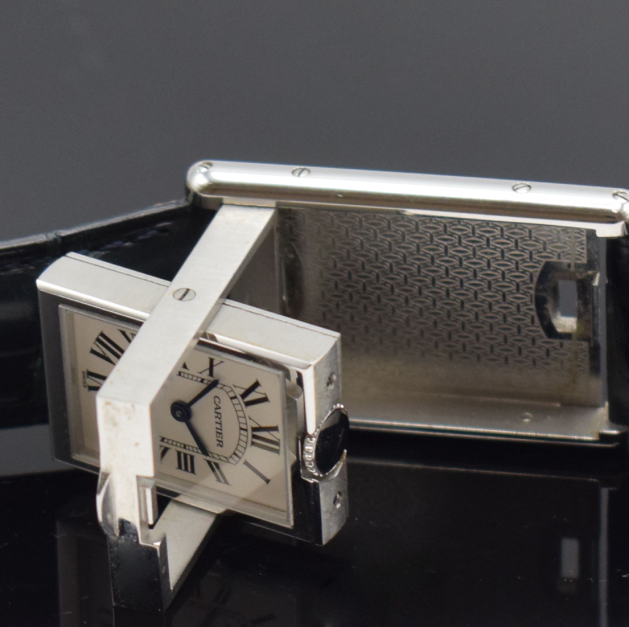 Detail e: CARTIER Basculante Armbanduhr Referenz 2405, Schweiz um 2005, quarz, aufwendiges Edelstahl Wendegehäuse inkl. orig. Lederband m. orig. Dornschl., ...