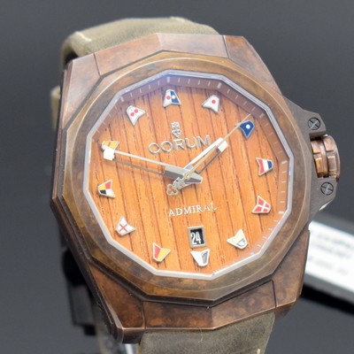 26589902c - CORUM gents wristwatch Admiral´s Cup AC-One 45 Bronze reference 082.500.53/0F62 AW02, self winding, on both sides gold-plated Bronze case including original leather strap with butterfly buckle, screwed down case back, wood-dial with raised nautical pennants, display of hour, minutes, sweep seconds & date, dodecagonal bezel, diameter approx. 45 mm, original box & blank papers, unworn, condition 1
