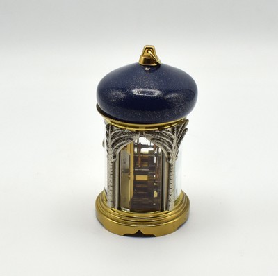 26601968b - MATTHEW NORMAN small 8-days-carriage clock in oriental style, Switzerland around 1985, oval 4-side glazed brass case, blue/gold-painted head with loop, silvered palm-shaped pillars, gold plated and polished movement with lever- escapement, original box and papers enclosed, measures approx. 92 x 60 x 51 mm, hairspring has to be replaced, needs to be overhauled, condition 3