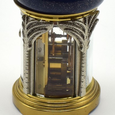 26601968c - MATTHEW NORMAN small 8-days-carriage clock in oriental style, Switzerland around 1985, oval 4-side glazed brass case, blue/gold-painted head with loop, silvered palm-shaped pillars, gold plated and polished movement with lever- escapement, original box and papers enclosed, measures approx. 92 x 60 x 51 mm, hairspring has to be replaced, needs to be overhauled, condition 3