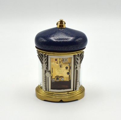 26601968d - MATTHEW NORMAN small 8-days-carriage clock in oriental style, Switzerland around 1985, oval 4-side glazed brass case, blue/gold-painted head with loop, silvered palm-shaped pillars, gold plated and polished movement with lever- escapement, original box and papers enclosed, measures approx. 92 x 60 x 51 mm, hairspring has to be replaced, needs to be overhauled, condition 3