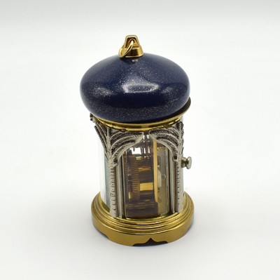 26601968f - MATTHEW NORMAN small 8-days-carriage clock in oriental style, Switzerland around 1985, oval 4-side glazed brass case, blue/gold-painted head with loop, silvered palm-shaped pillars, gold plated and polished movement with lever- escapement, original box and papers enclosed, measures approx. 92 x 60 x 51 mm, hairspring has to be replaced, needs to be overhauled, condition 3