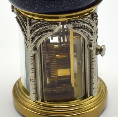 26601968g - MATTHEW NORMAN small 8-days-carriage clock in oriental style, Switzerland around 1985, oval 4-side glazed brass case, blue/gold-painted head with loop, silvered palm-shaped pillars, gold plated and polished movement with lever- escapement, original box and papers enclosed, measures approx. 92 x 60 x 51 mm, hairspring has to be replaced, needs to be overhauled, condition 3