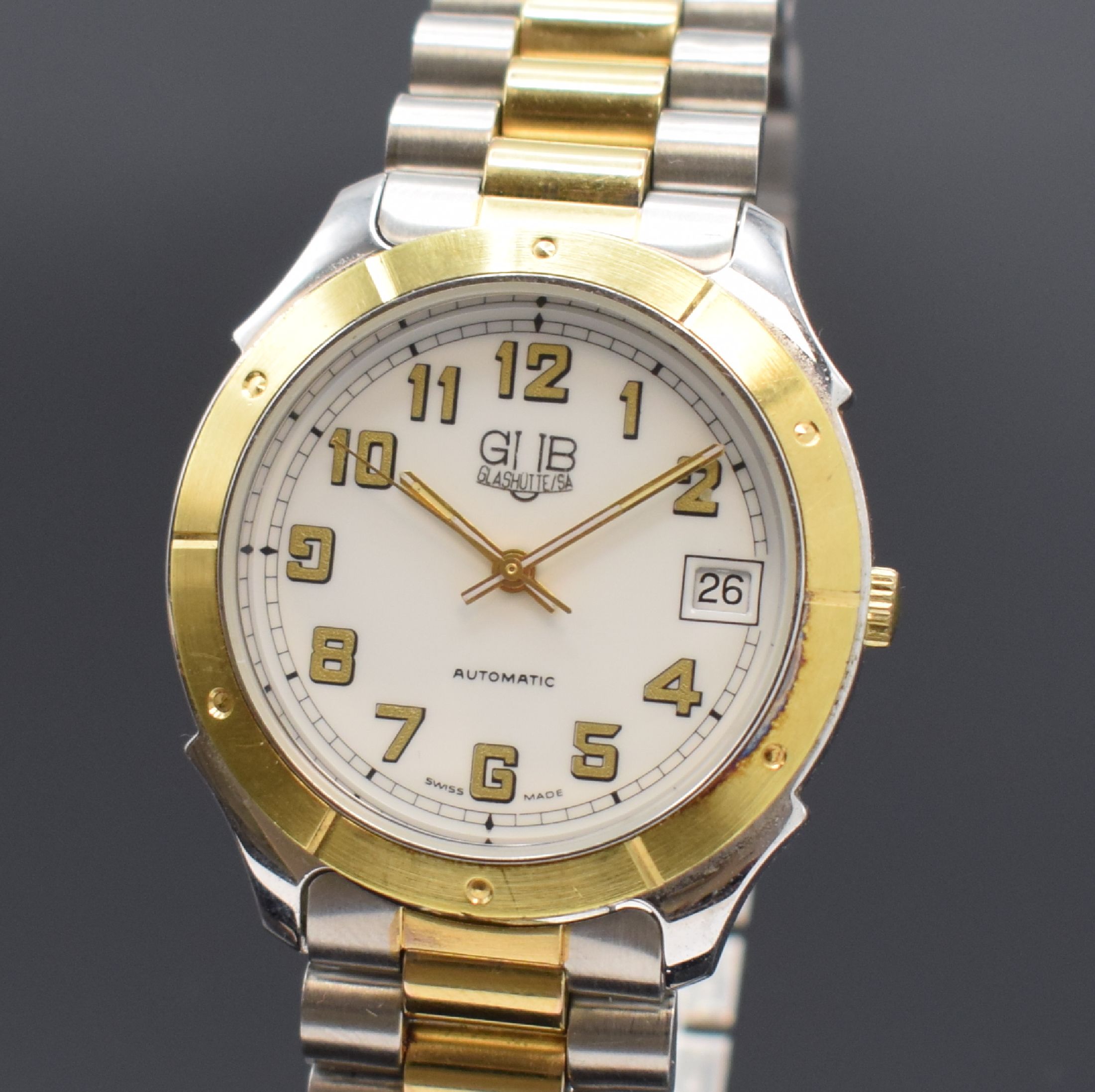 Detail a: GUB Glashütte/SA Herrenarmbanduhr, Deutschland um 1990, Automatik, beids. vergl. z. T. verg./verchr., Gliederband m. Faltschl.,Boden aufgedr., ...