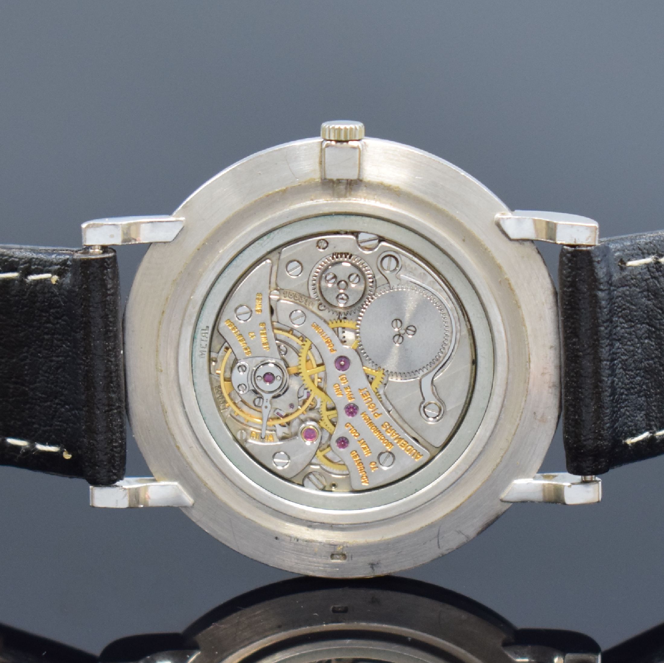 Detail e: AUDEMARS PIGUET Herrenarmbanduhr in WG 750/000, Schweiz um 1980, Handaufzug, 3-teil. Geh., Boden und Glasrand aufgedr., schwarzes Zifferbl., silb. ...