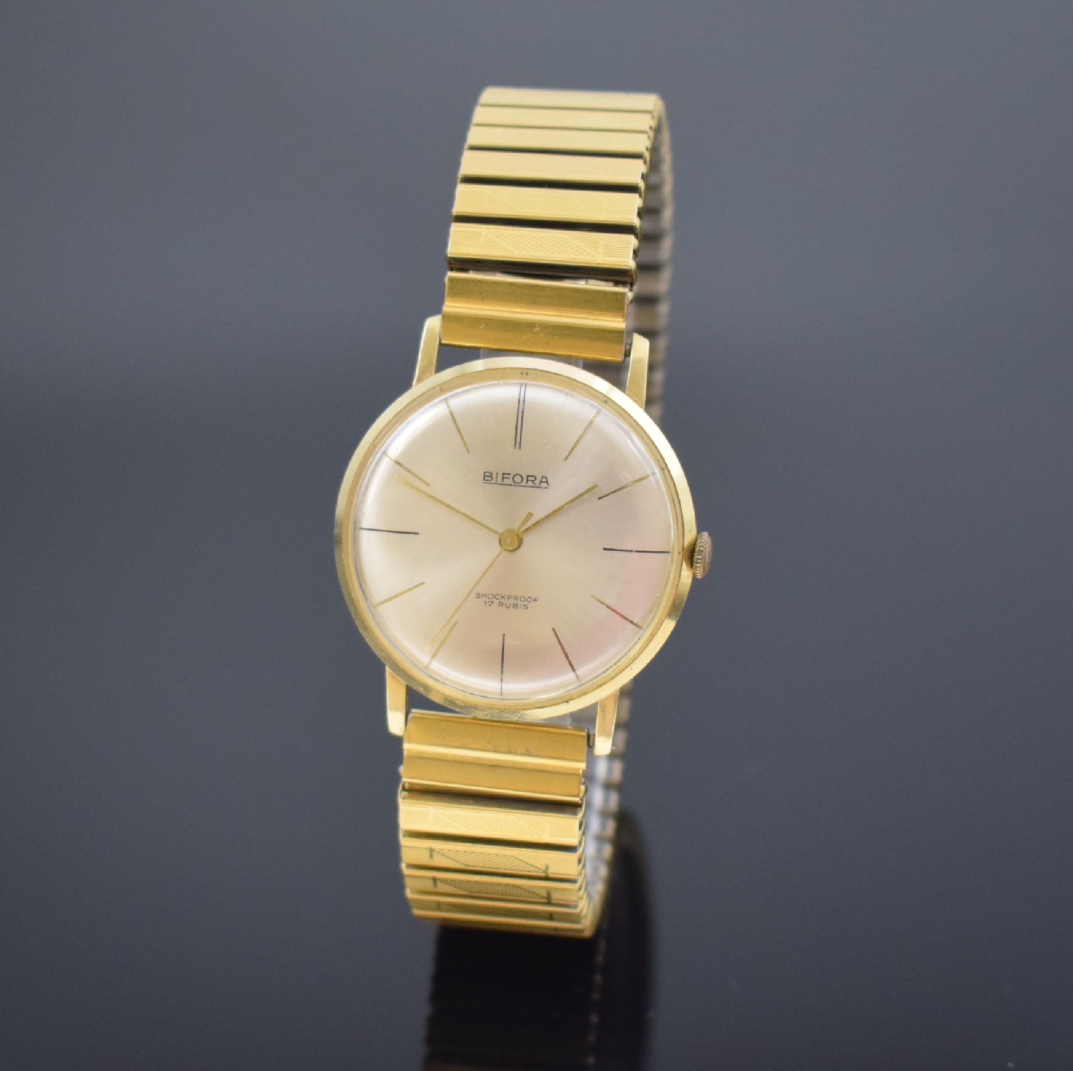 BIFORA Herrenarmbanduhr in GG 585/000, Schweiz um 1970, Handaufzug, Boden aufgedr., verg. Flexband, silb. Zifferbl. m. gold. Std.-Ind., gold. Zeiger, ...