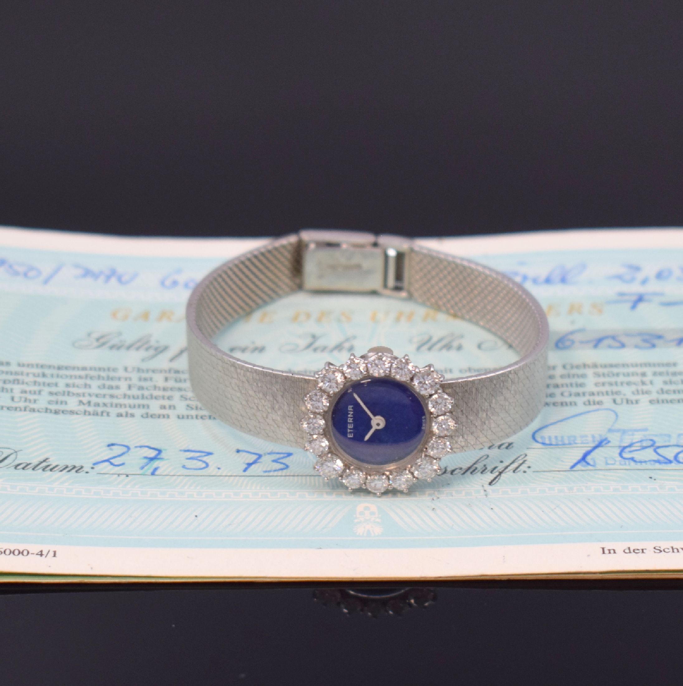 ETERNA Damenarmbanduhr in WG 750/000 mit Diamanten, Schweiz verk. lt. beil. Garantie 03/1973, Handaufzug, Geh. an Goldband 750/000, Boden aufgedr., ...